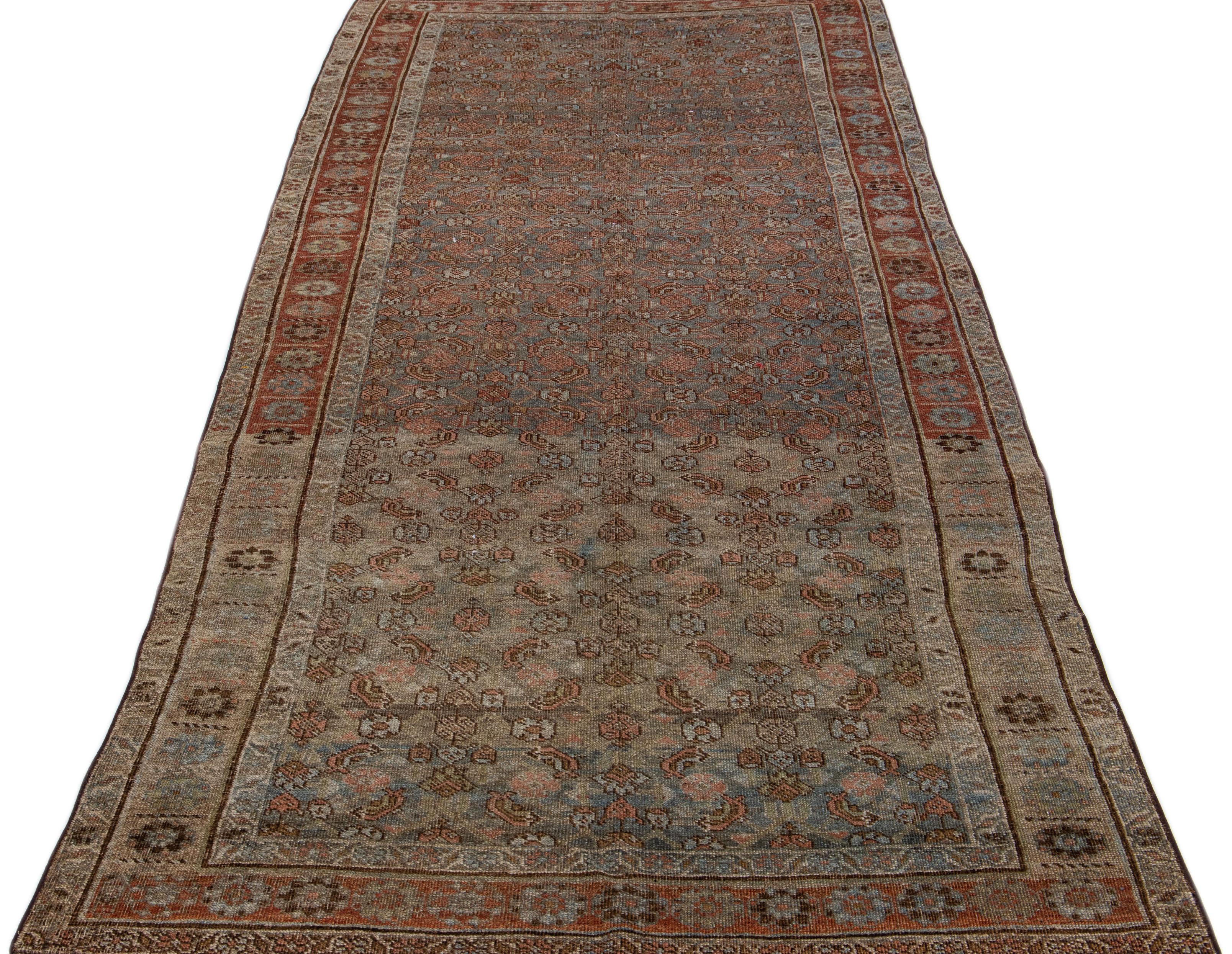 Beautiful antique Malayer hand-knotted wool rug with a blue color field. This Persian rug has rust accents in a gorgeous traditional floral design.

This rug measures 4'9