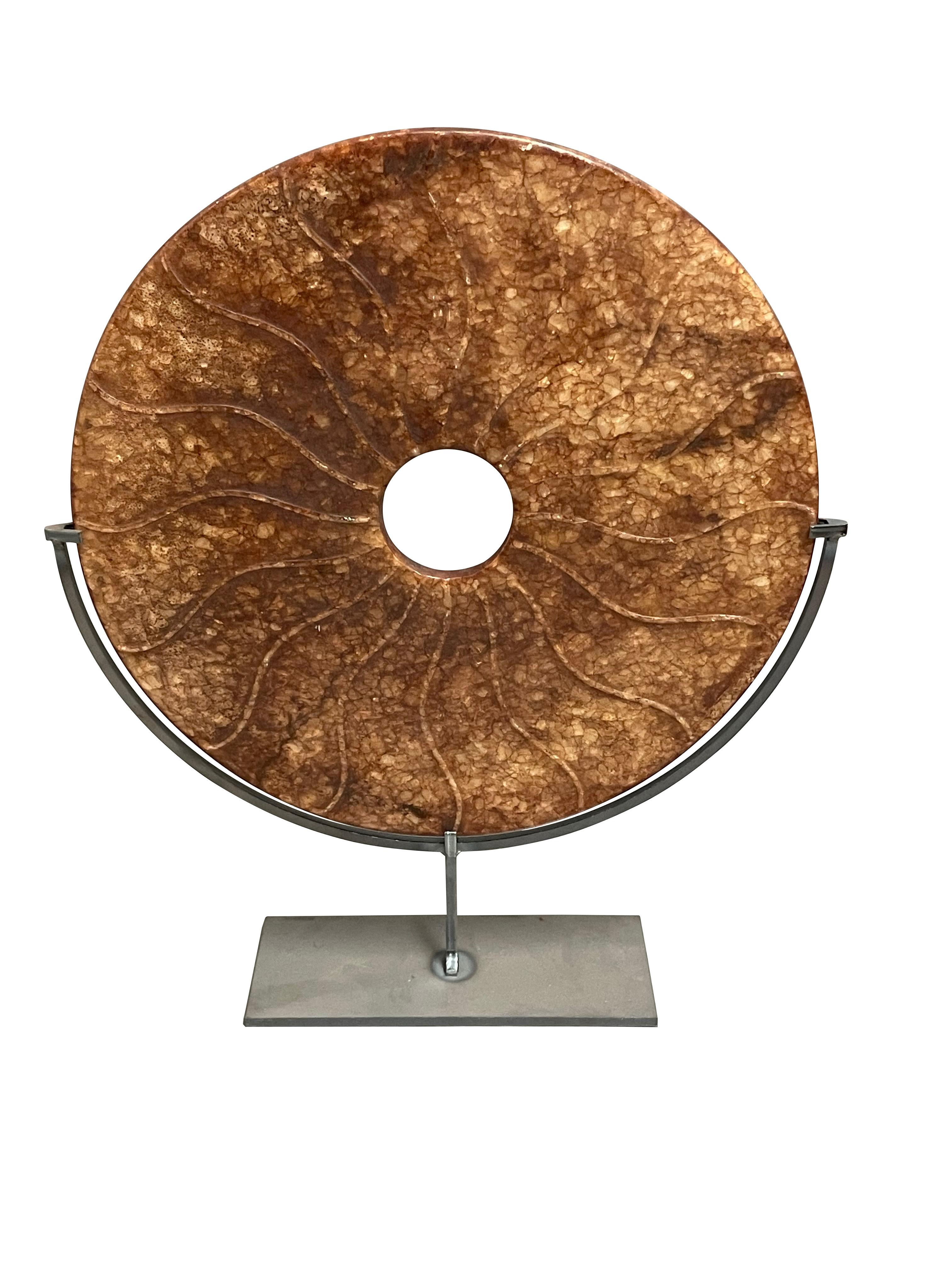 Contemporary Chinese set of three rust and gold colored jade discs.
Concentric circle design disc measures  9d  x  12h      
stand measures   7  x  3
Textured disc measures   12d  x  15h    
stand measures  7   x  3.5
Three handle disc measures    