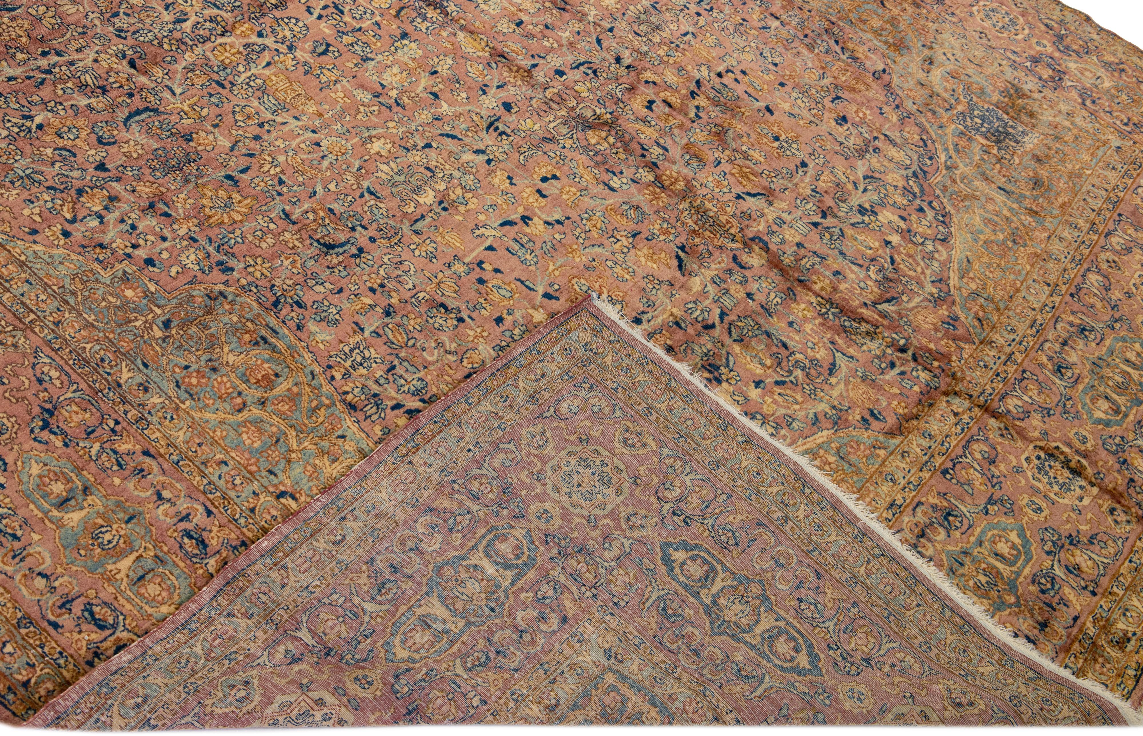 Beautiful antique Kerman hand-knotted wool rug with a red-rust field. This Kerman rug has multicolor accents in a gorgeous all-over medallion floral pattern design.

This rug measures: 8'1