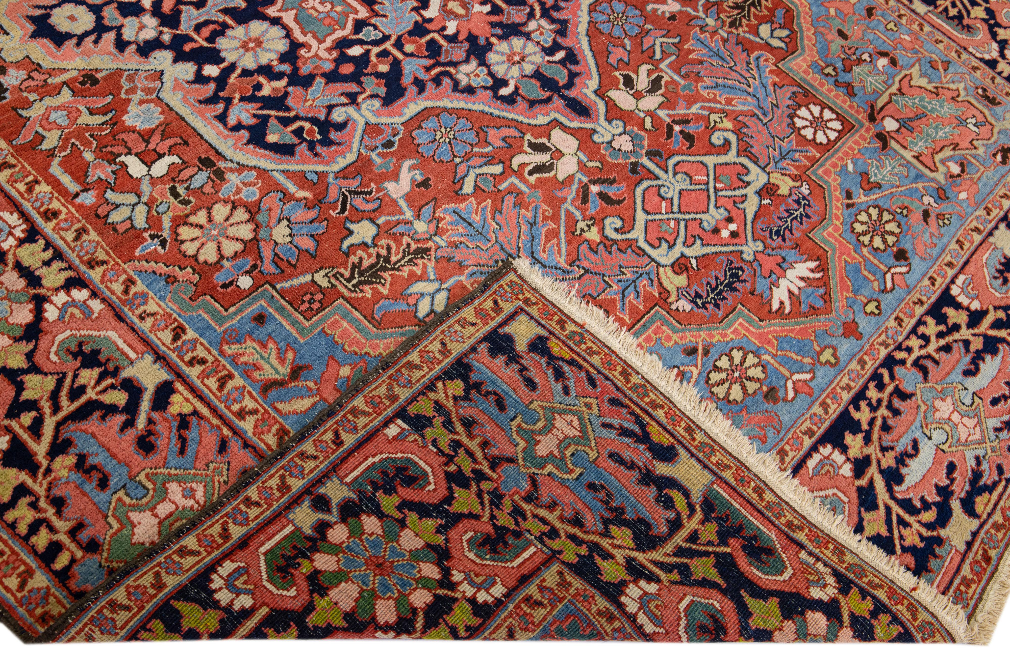 Beautiful antique Heriz hand-knotted wool rug with a rust color field. This Persian rug has multicolor accents in a gorgeous medallion floral design.

This rug measures: 8'3