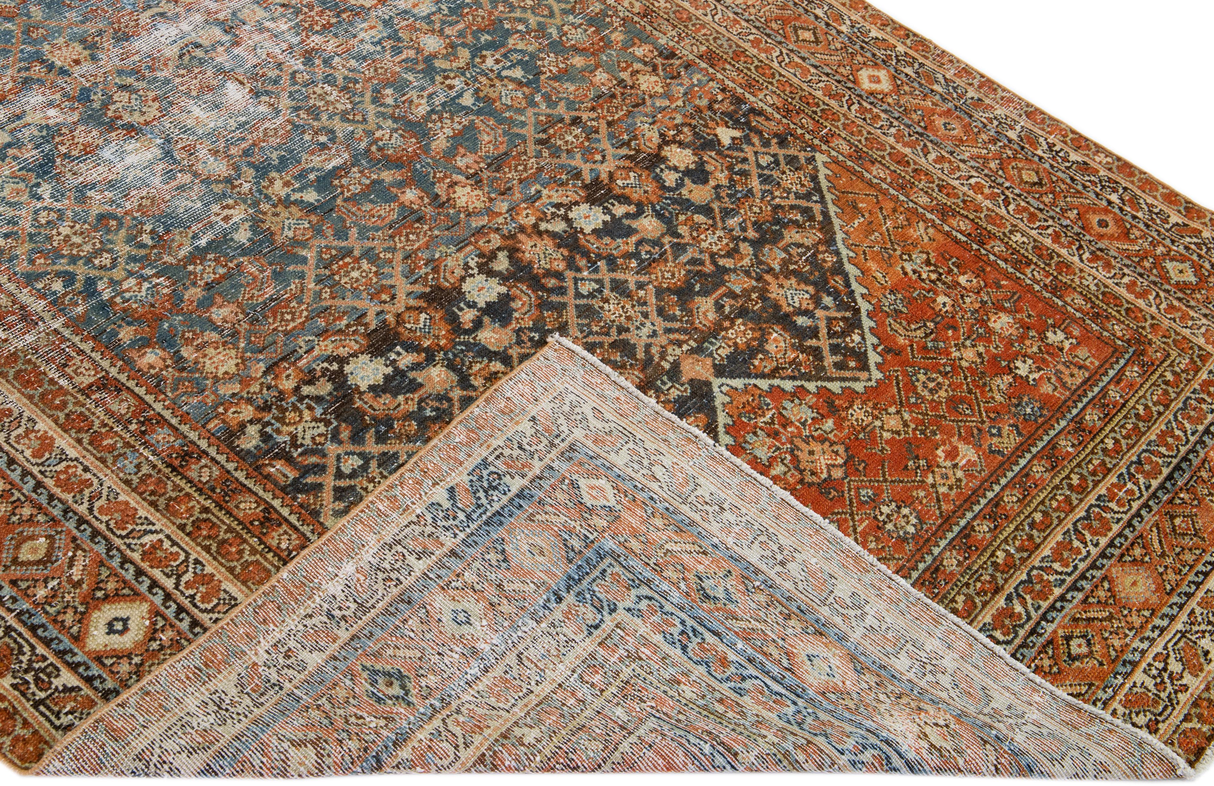 Beautiful antique Malayer hand-knotted wool rug with a blue field. This Persian piece has orange-rust and brown accent colors in a gorgeous all-over floral design.

This rug measures: 5'9