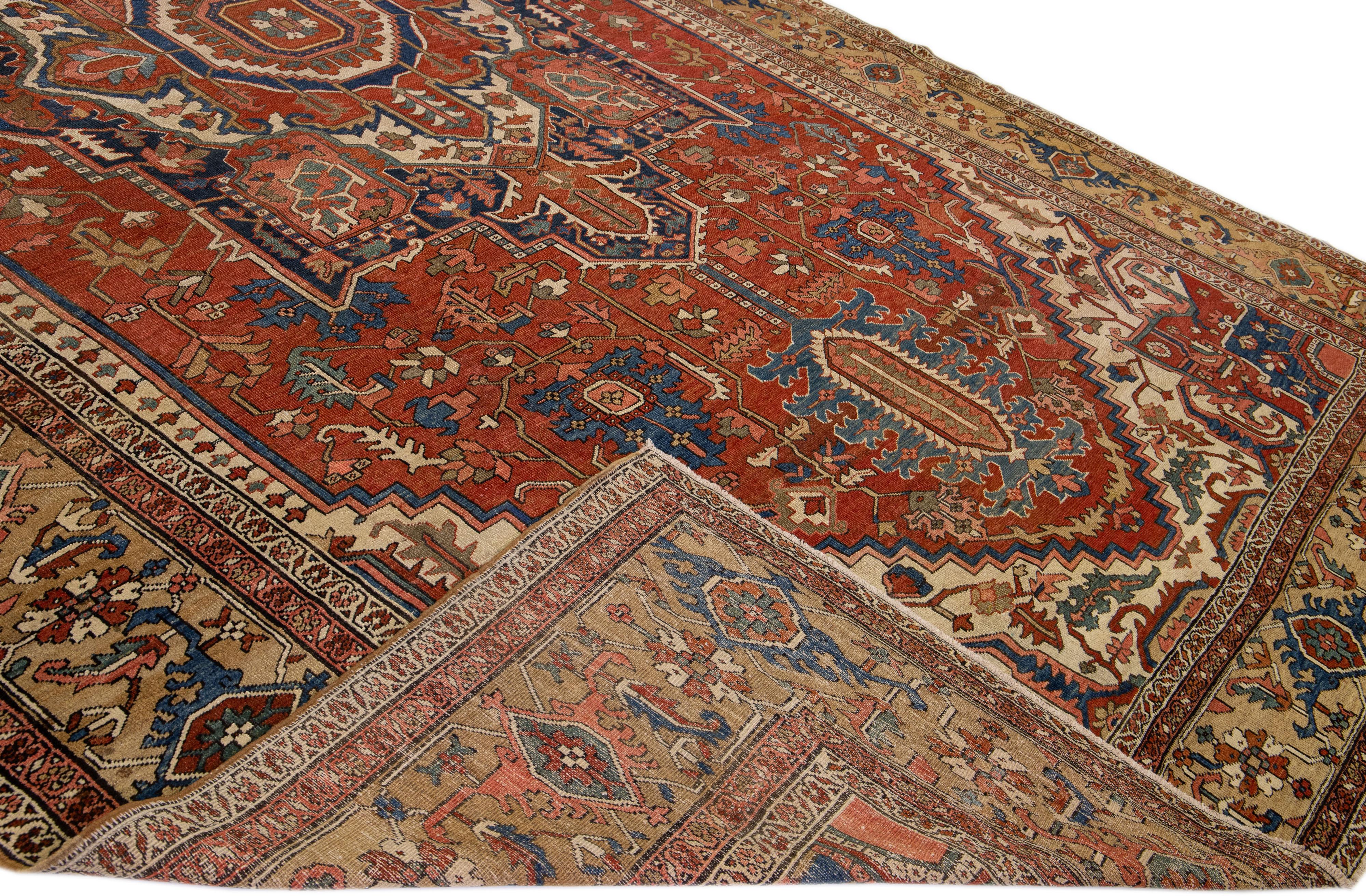 Beautiful Antique Serapi hand-knotted wool rug with a rust field. This Persian rug has a brown frame and multi-color accents in a gorgeous all-over geometric floral medallion design.

This rug measures: 11'7
