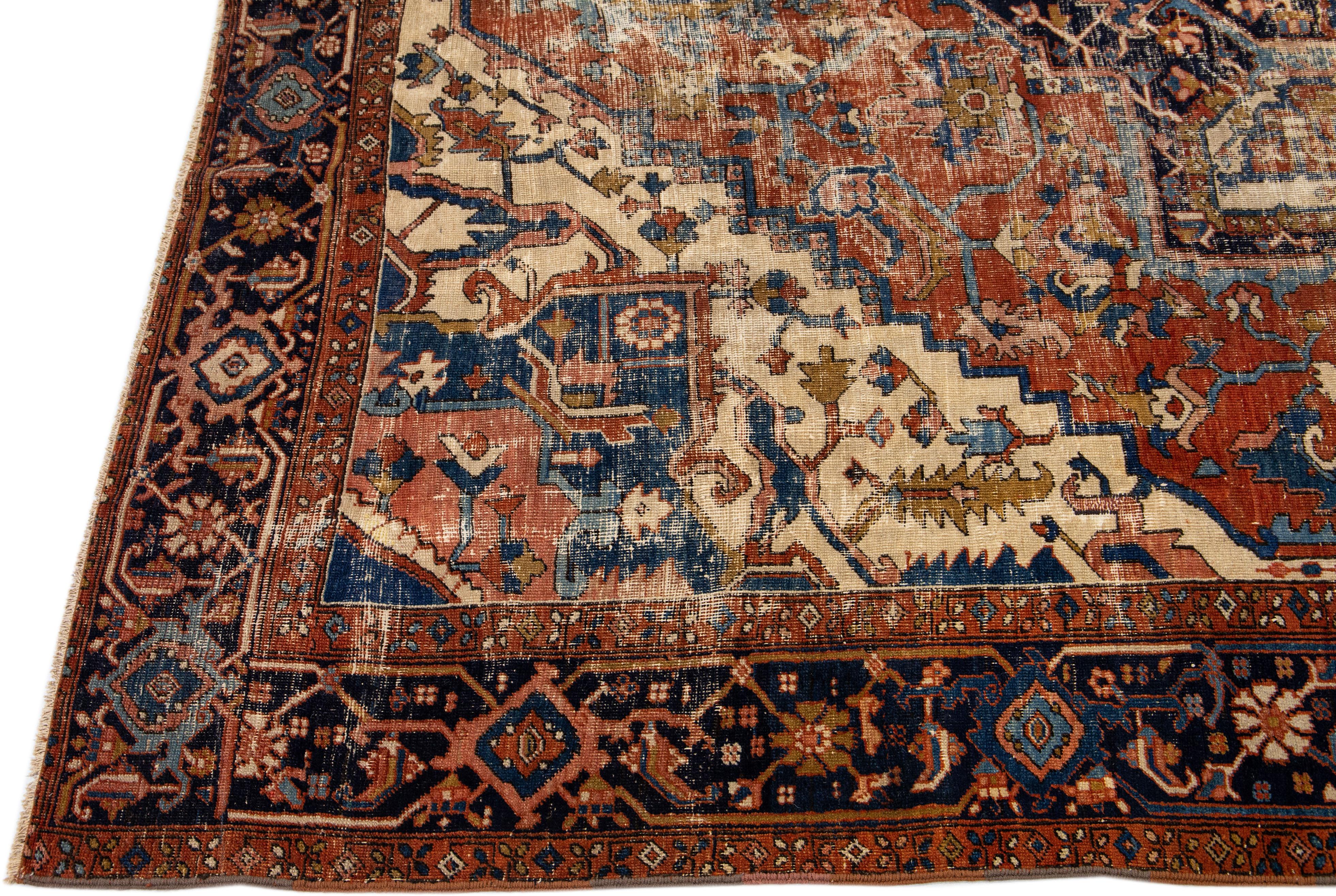 Beautiful antique Heriz hand-knotted wool rug with a rust color field. This Persian rug has multicolor accents in a gorgeous medallion floral design.

This rug measures: 8'11