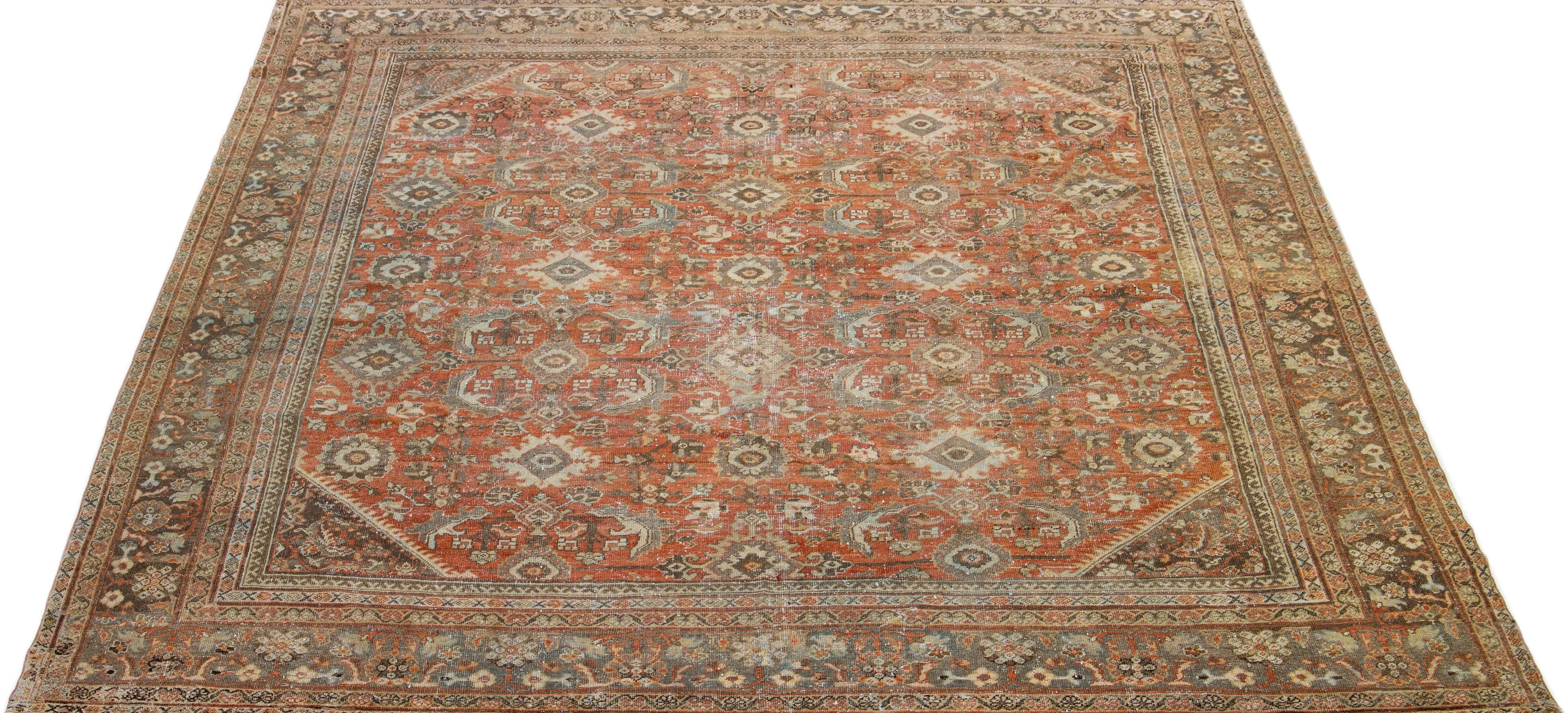 Beautiful hand-knotted antique mahal wool rug with a red color field. This Persian rug has blue and brown accent colors in an all-over floral design. 

This rug measures: 10'4