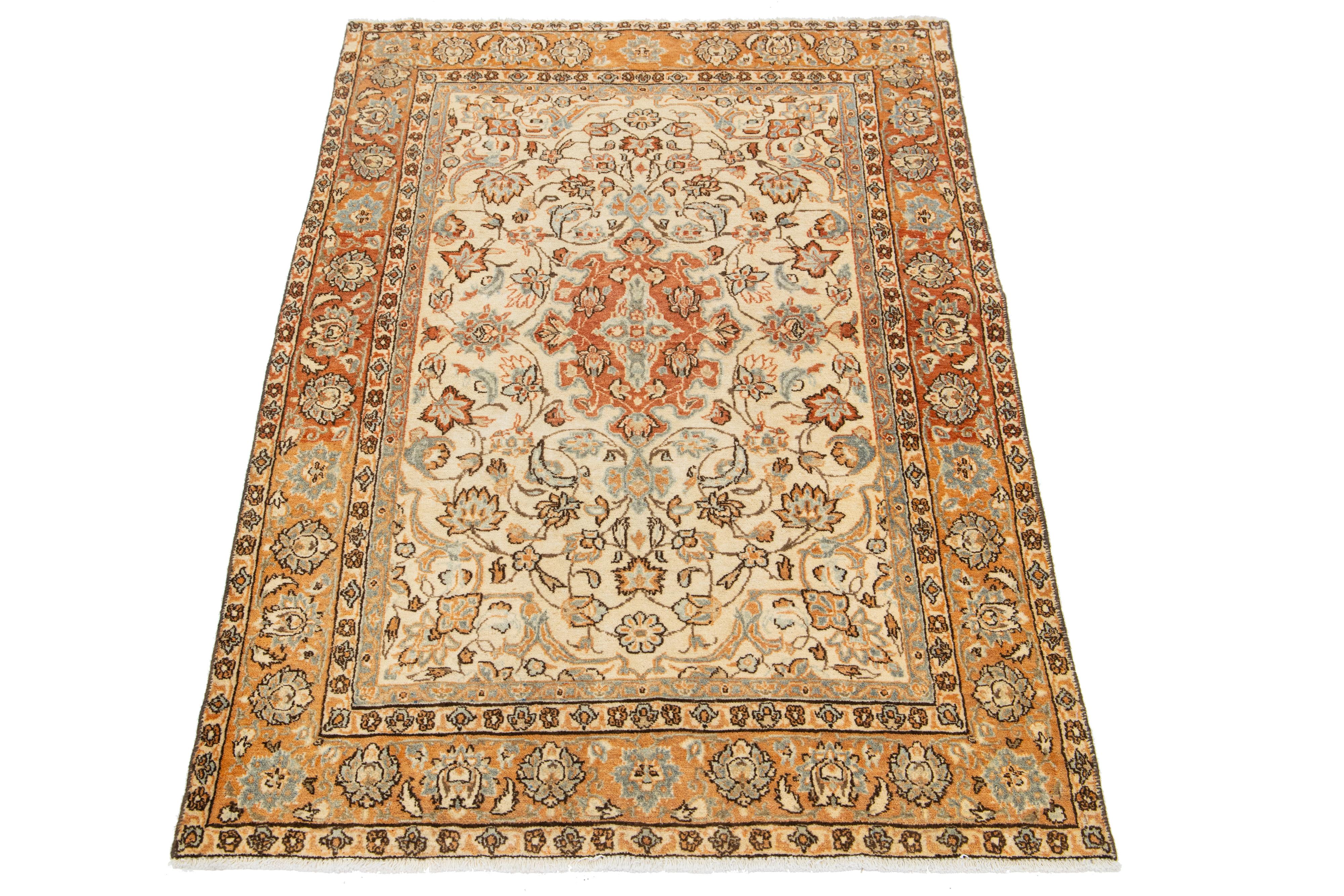 This is a beautiful Vintage Mahal hand-knotted wool rug with a beige-colored field. The floral motif of this Persian rug is adorned with gray, rust, and brown hues.

This rug measures 3'4