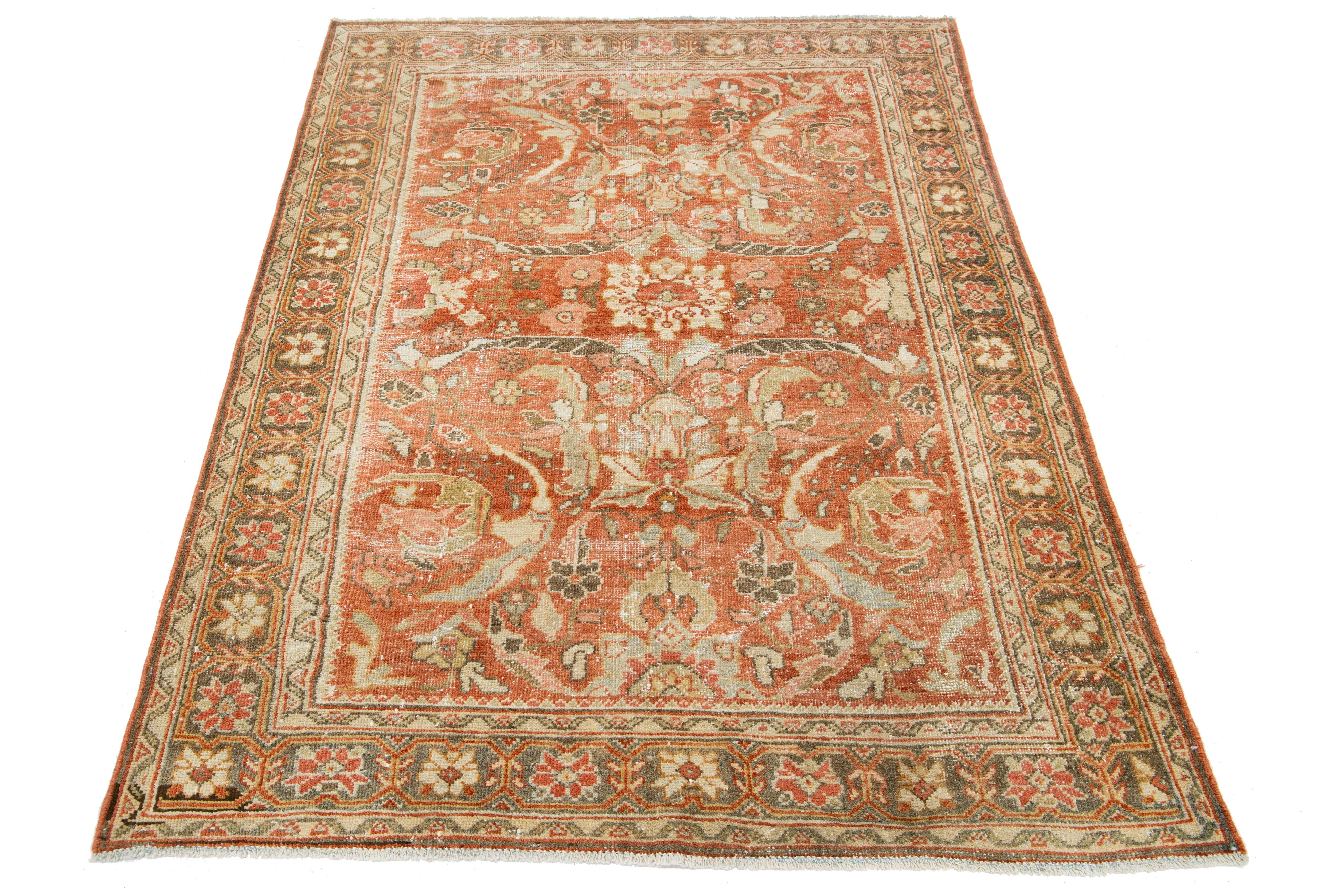 Beautiful Vintage Mahal hand-knotted wool rug with a rust color field. This Persian rug has beige, gray, pink, and brown hues throughout the floral motif.

This rug measures 5'1