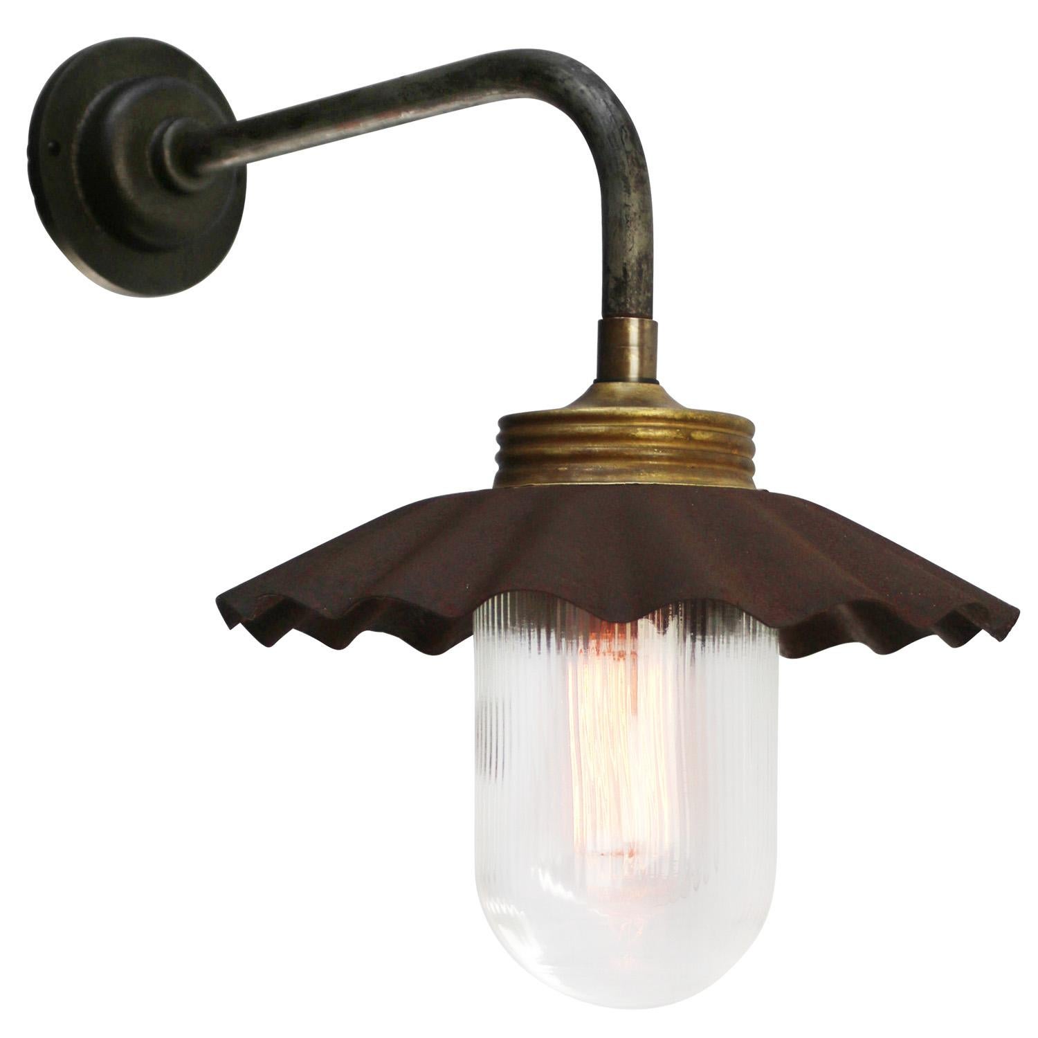 Rust Cast Iron Barn light
Brass top with clear striped glass

Diameter cast iron wall piece: 10.5 cm / 4 inches
2 holes to secure

Weight: 2.40 kg / 5.3 lb

Priced per individual item. All lamps have been made suitable by international standards for