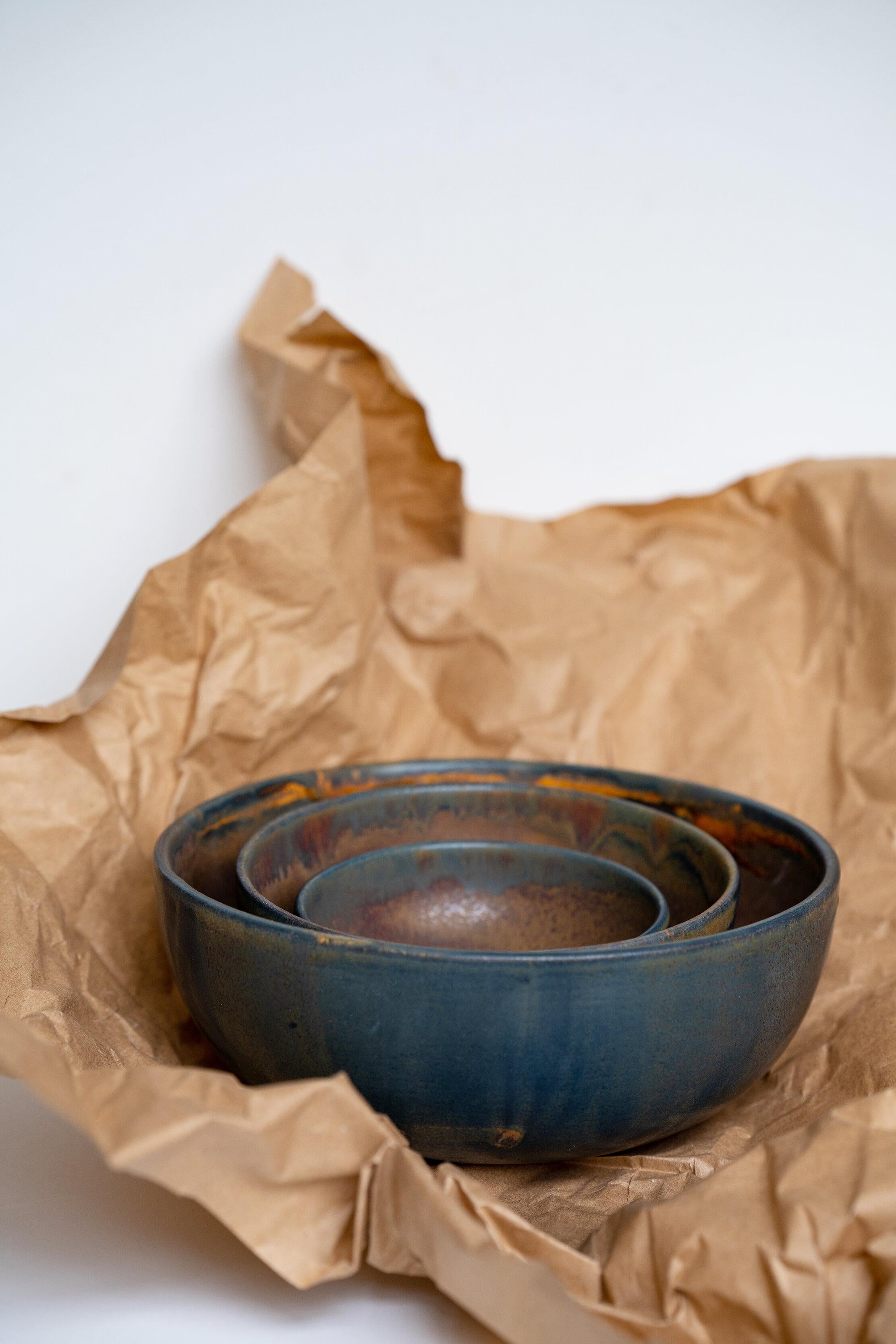 Matte brown-black nesting bowl set brings pottery vibes to mealtime. Hand-dipped in a reactive glaze that swirls uniquely across each piece. Open form and simple style only add character to this dinnerware. Perfect for serving, mixing, storing and