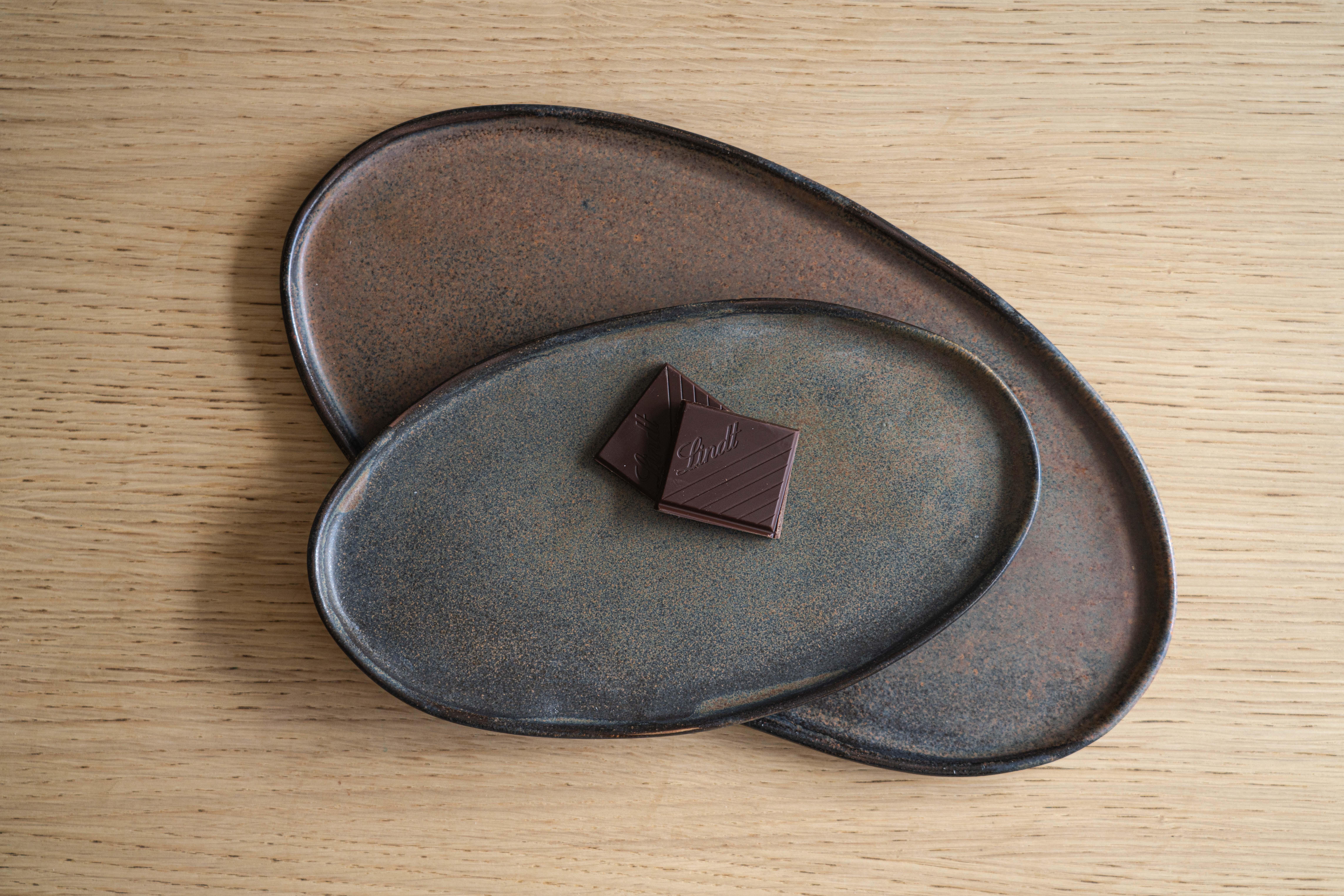 A handmade stoneware serving platter with organic round edges works perfectly for everyday and special occasions alike. The oval shape of this platter makes it easier to set the table. Hand-dipped in a reactive glaze that swirls uniquely across each