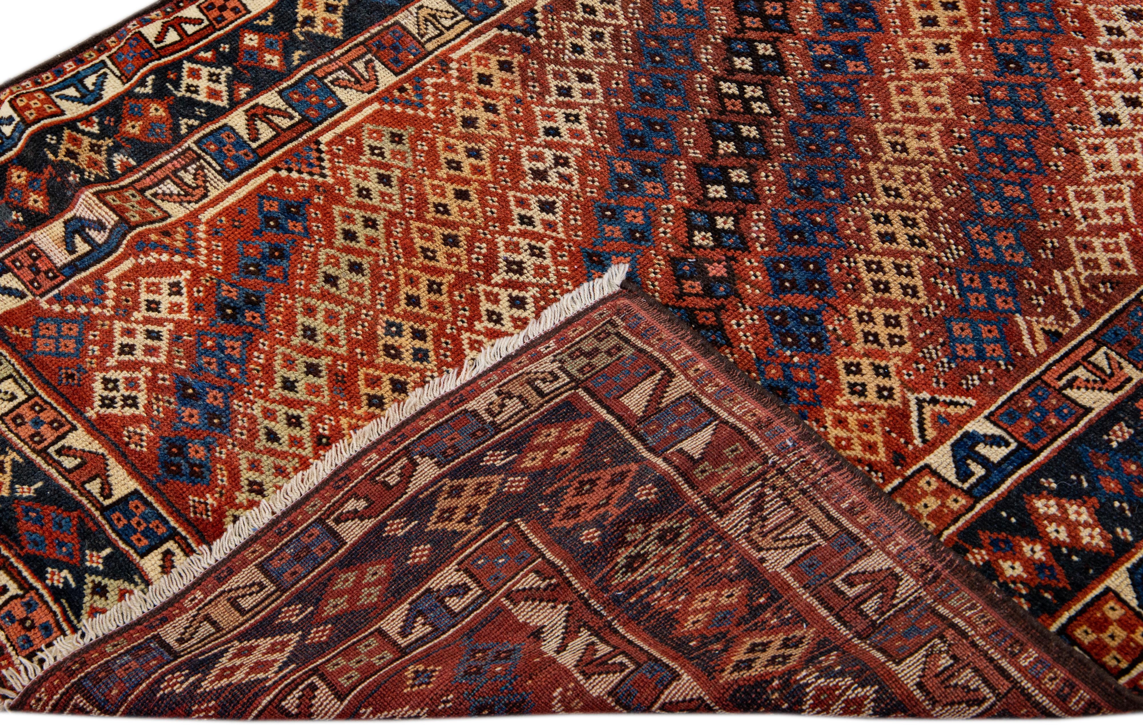 Beautiful modern Kurd hand-knotted wool runner with a rust field. This piece has multicolor accents in a gorgeous all-over geometric design.

This rug measures: 4'1