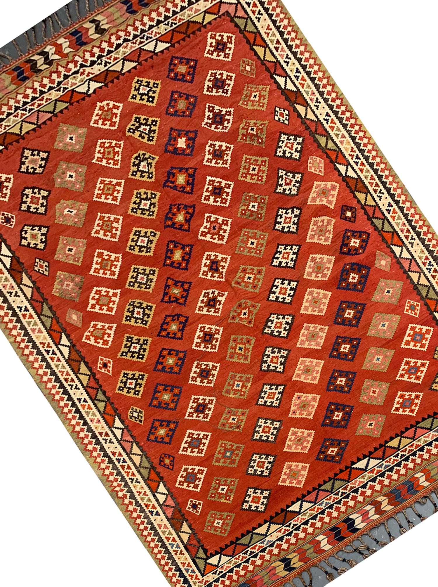 This piece is an excellent example of caucasian rugs woven by hand in the 1890s with an elegant diagonal repeat motif pattern woven with accents of blue, green and beige. This has then been framed by a layered border with cream accents. Both the