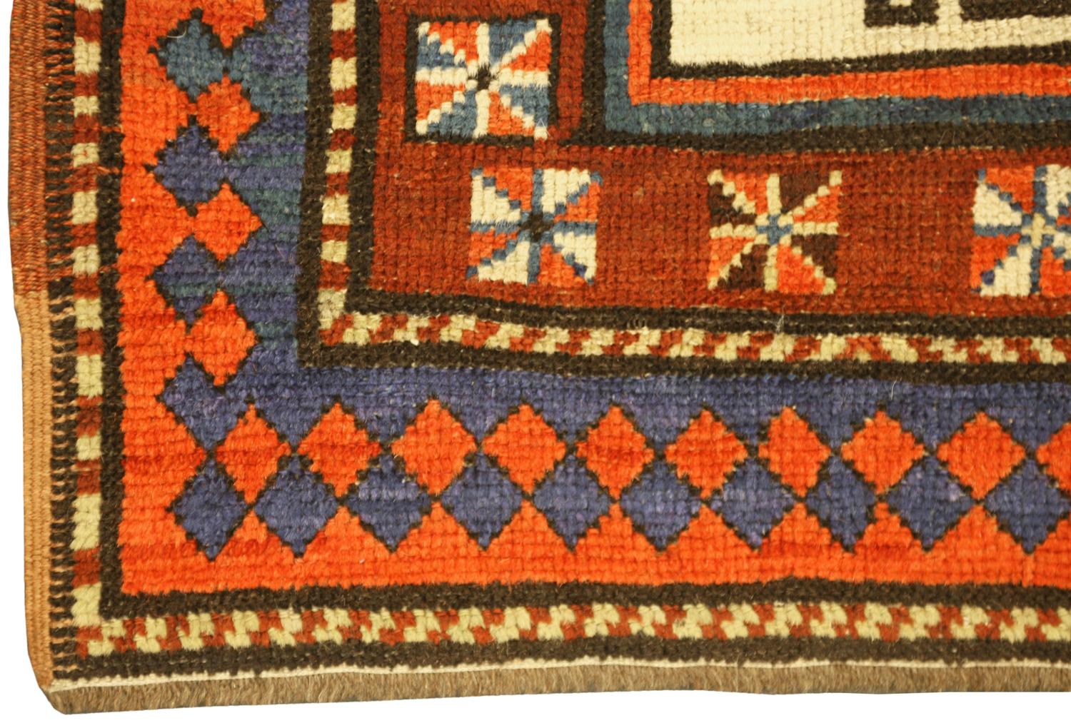 A fine Moghan runner, South Caucasus. The ivory field with two columns of multicolored hooked and stepped medallions divided by checkered lozenges and small hooked motifs. In rust rosette border between the arrowhead and barber-pole stripes.Good
