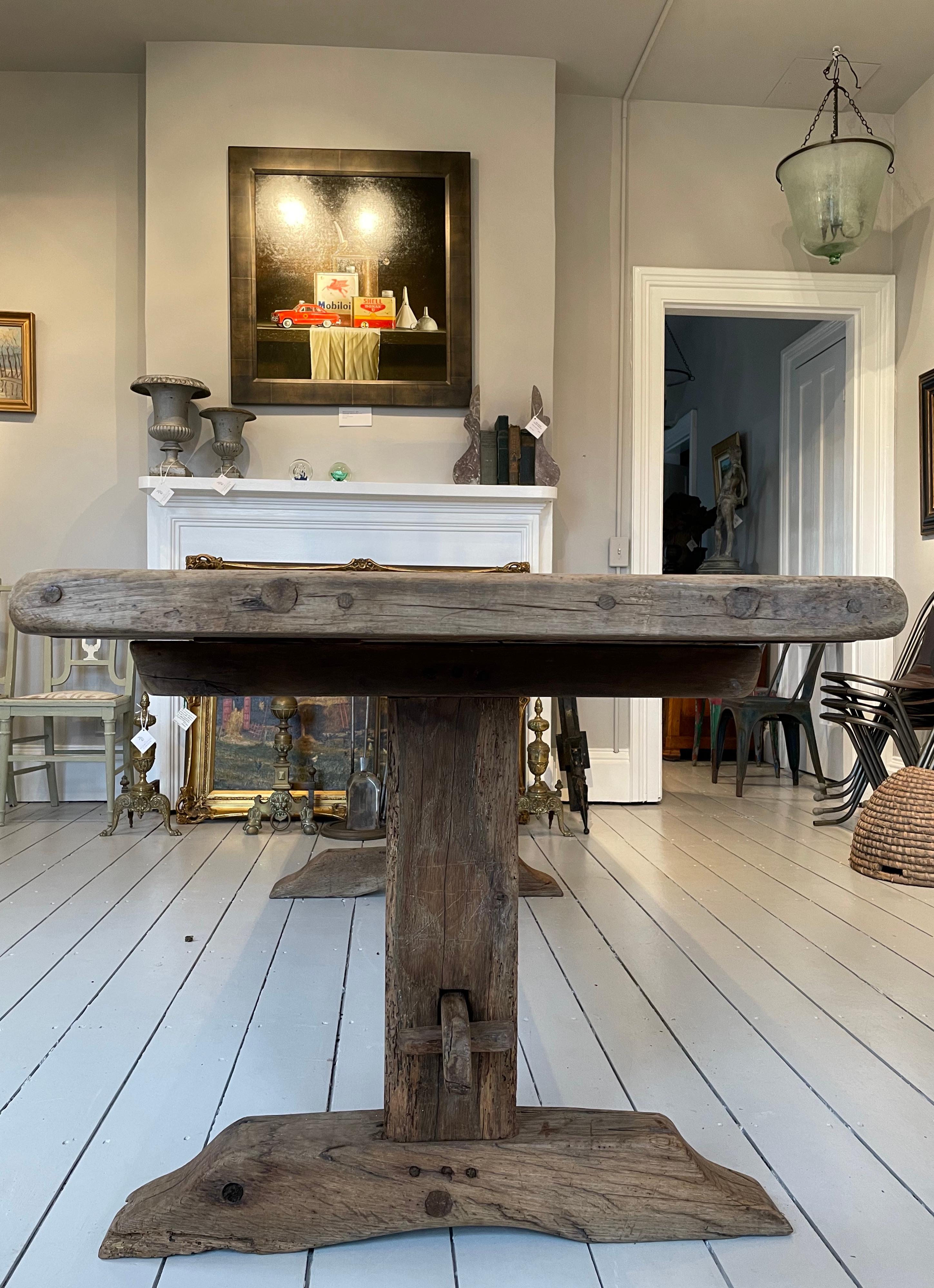 What a fabulous find! Perfect for dinner for eight, this beautiful hand-made oak trestle table actually breaks down into four pieces (all hand-pegged) and is a snap to reassemble. It features a stunning medium-tone surface with characterful swirling