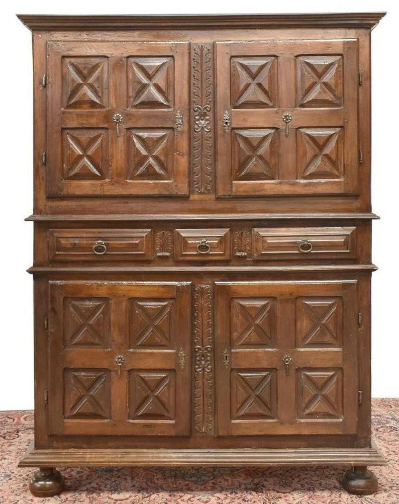 A handsome over 200 hundred year old rustic Spanish Baroque oak paneled cabinet with nicely aged warm rich dark patina. circa 1775

Hand-crafted in Spain in the 18th century, possibly very early 19th century. Large two-piece solid wood construction,