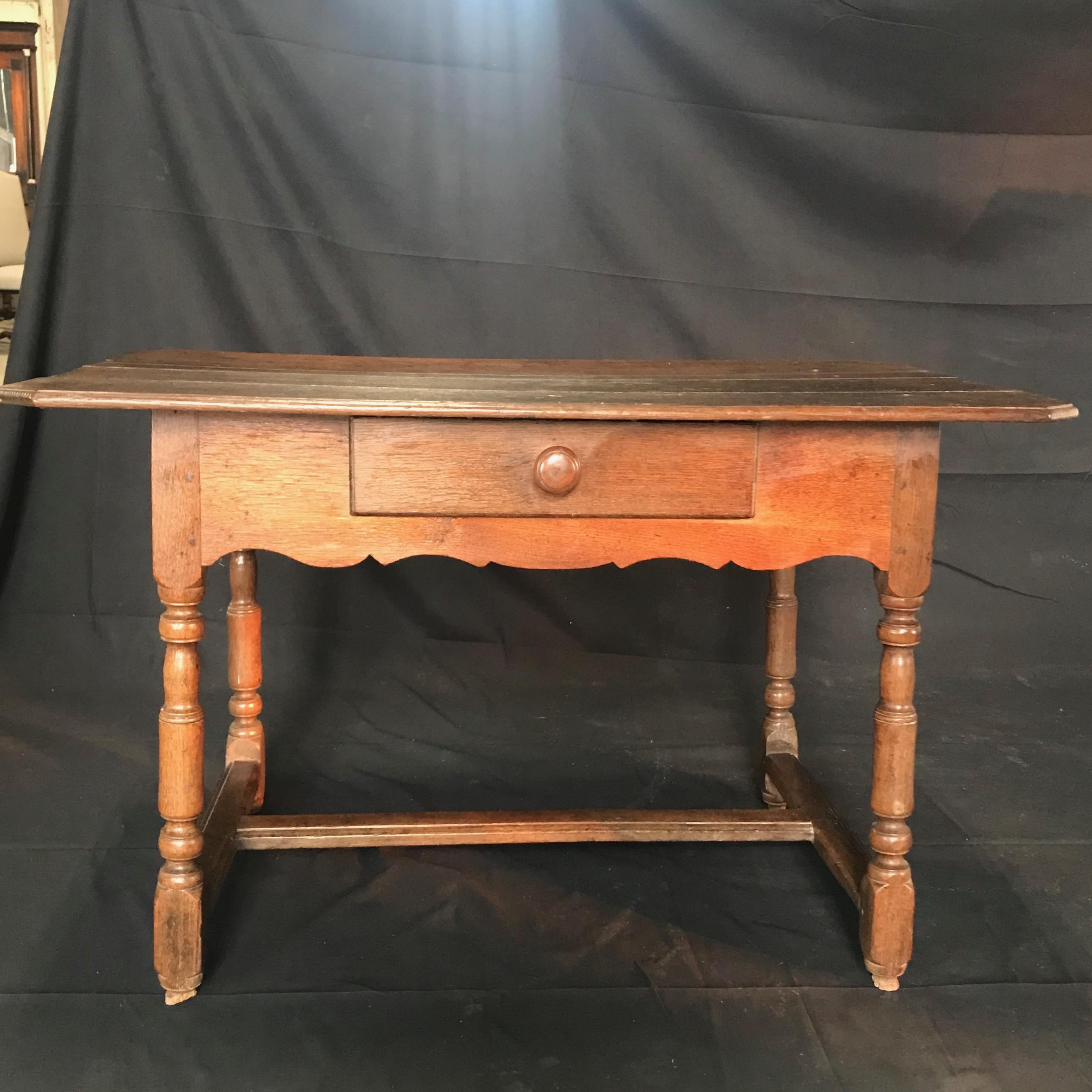 Beautiful rustic 19th century French country walnut table having wonderful patina, turned Legs and scalloped apron with one drawer. Can serve as a side table or a desk. 
#4966

 H to apron 19.25”.