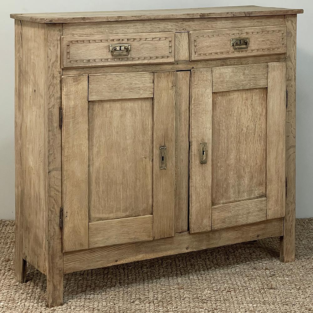 Rustic 19th Century French Louis Philippe Oak Buffet was hand-crafted from solid planks of old-growth oak by rural artisans primarily concerned with producing a storage and serving piece that would last for generations, rather than creating a style