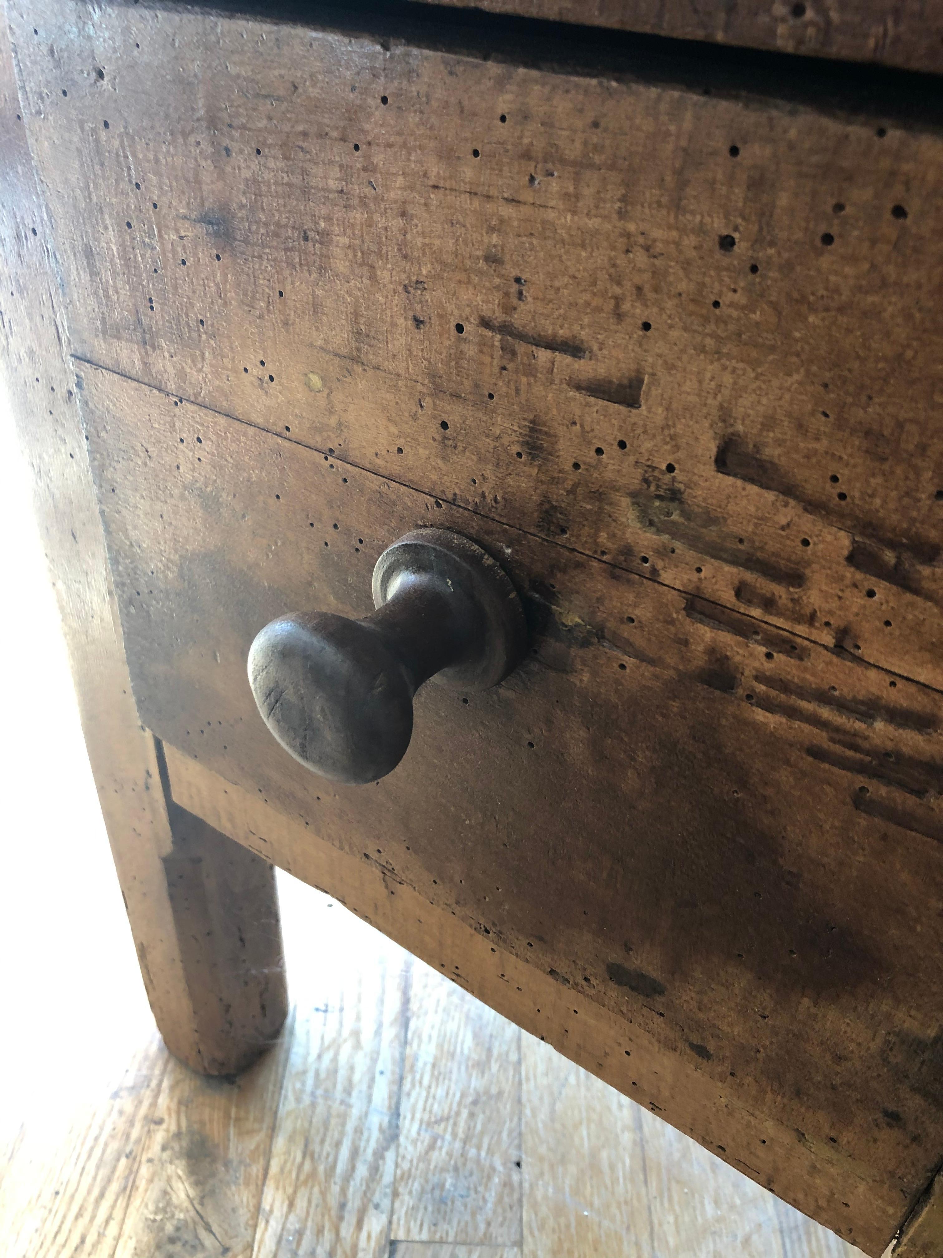 Small rustic 19th century French Provincial butchers table. Made of well dash worn beech with a deep patination and warm color. Single drawer with paneled sides and chamfered legs. Made in Normandy, circa 1880.