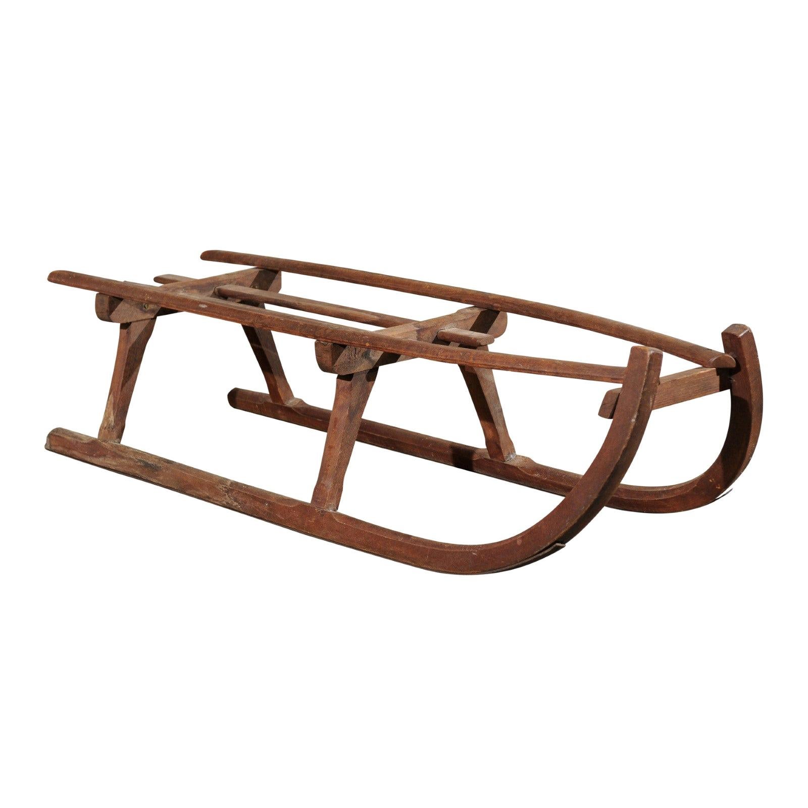 Rustic 19th Century French Wooden Sled with Weathered Patina and Curving Base For Sale