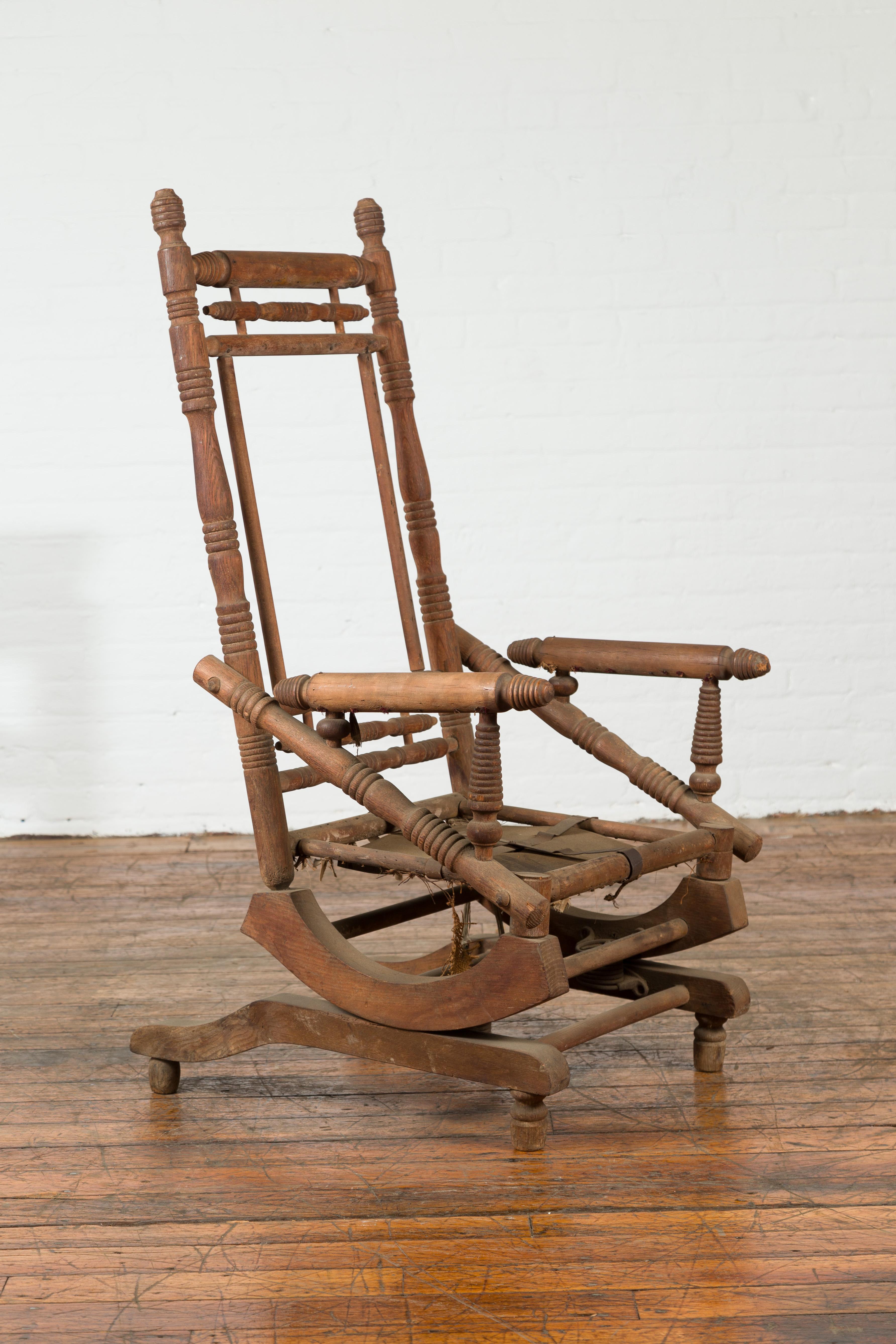 Wood Rustic 19th Century Indian Rocking Chair with Metal Accents and Turned Supports For Sale