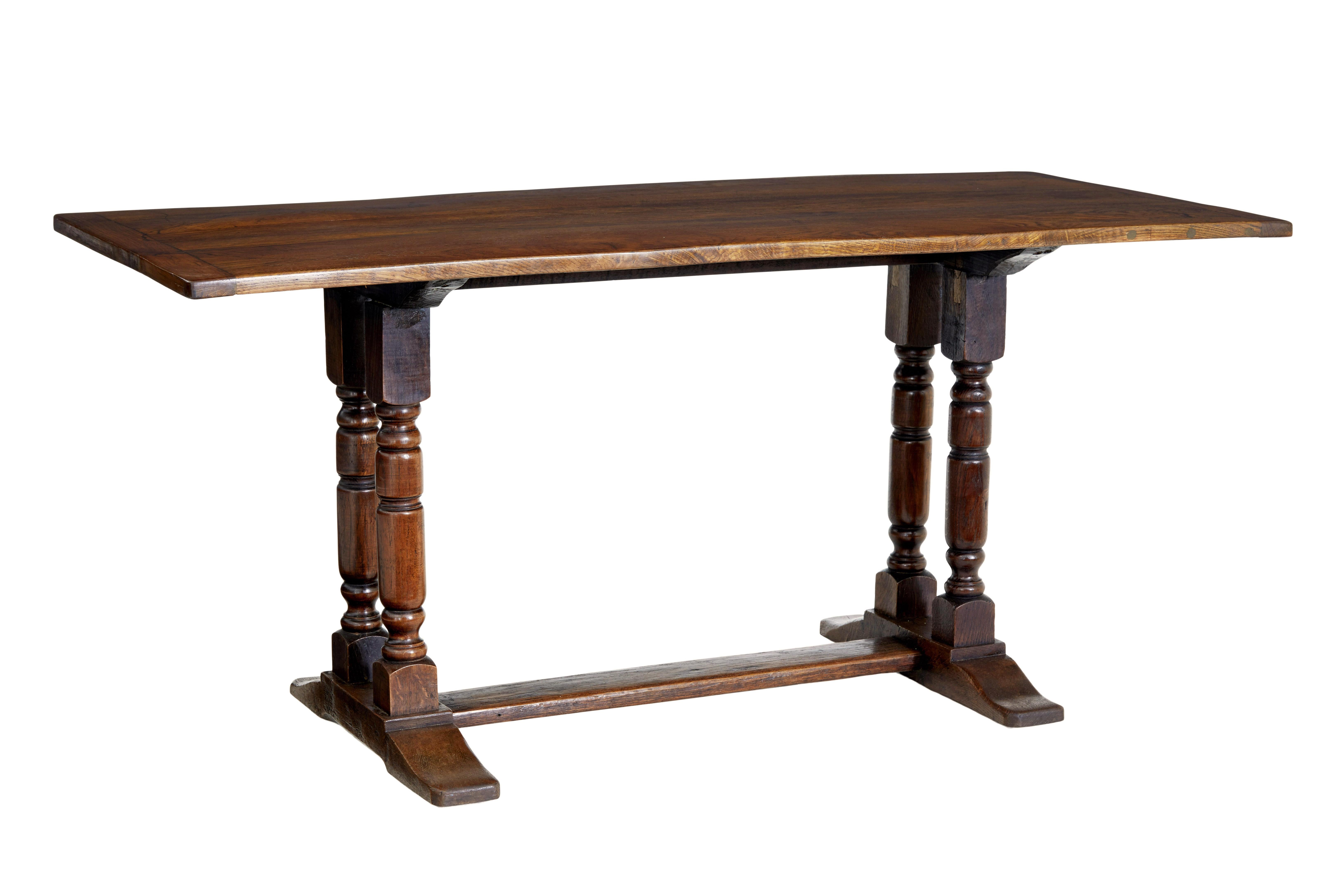 Rustic 19th century oak dining table circa 1850.

Old english small rectory style table made in oak.  4 plank oak top with cleated ends.  Standing on 2 turned supports with sledge feet united by a floor level stretcher.

This table would make an