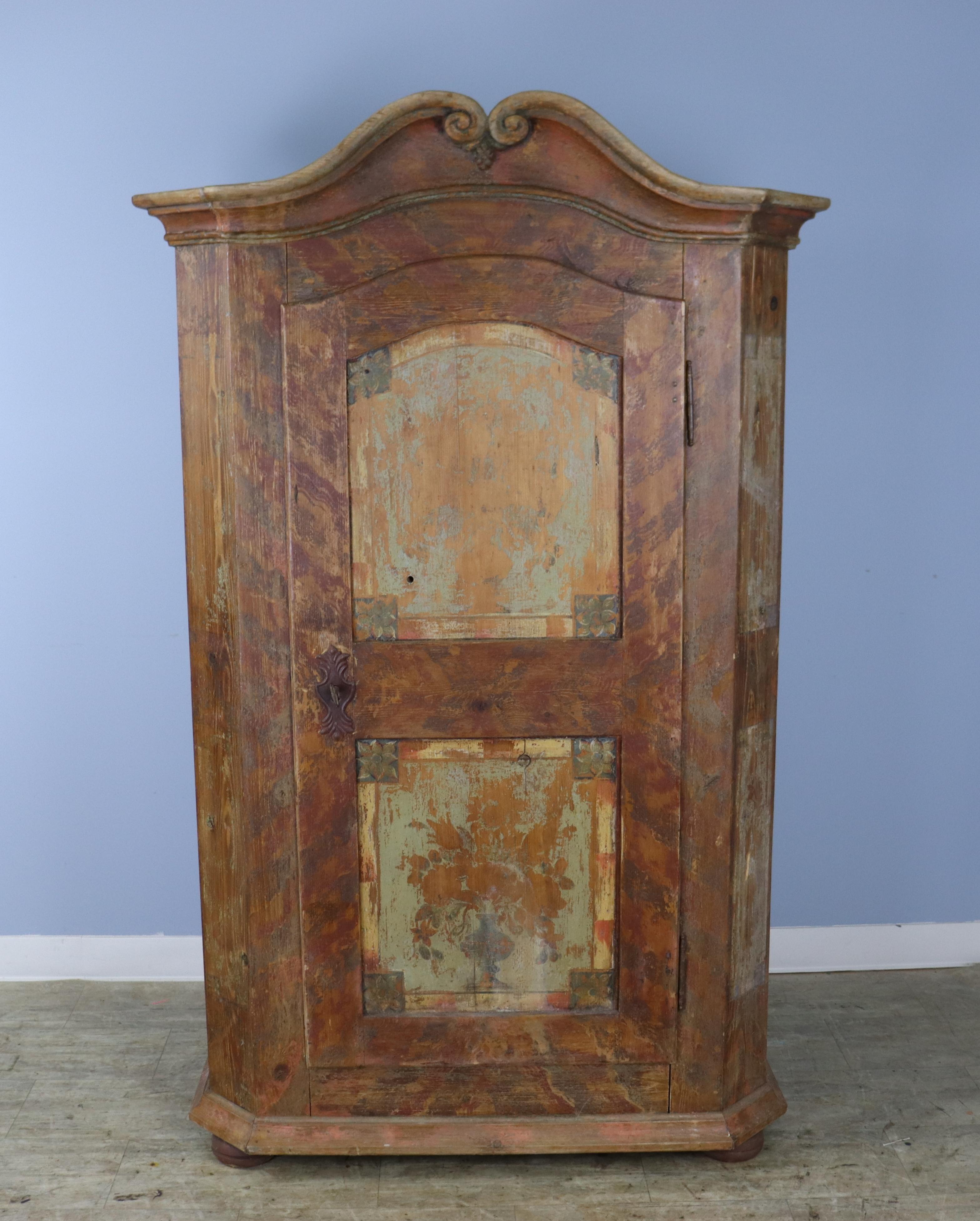 This 1890's  cabinet is a 19th Century copy of an early 18th Century French piece, faux distressed at the time it was made.   Inside, the piece is quite clean and has a roomy storage shelf as well as a bar for hanging clothes. The outstanding