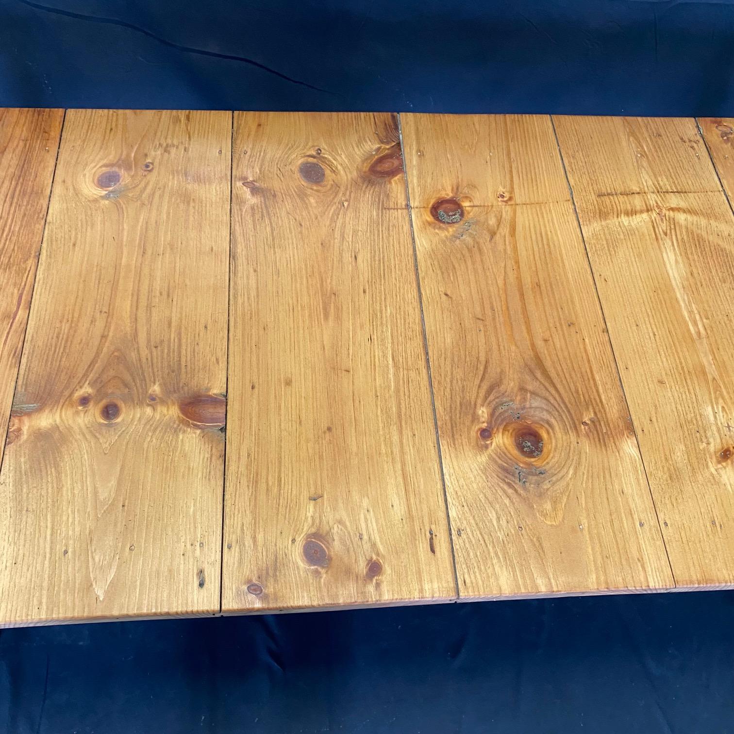 Classic Primitive style dining table in the farmhouse style is from an early Grange in Maine. Used since the 1800s to hold town meetings, it has been restored beautifully, yet retains its original paint on the body. All legs can be released and fold