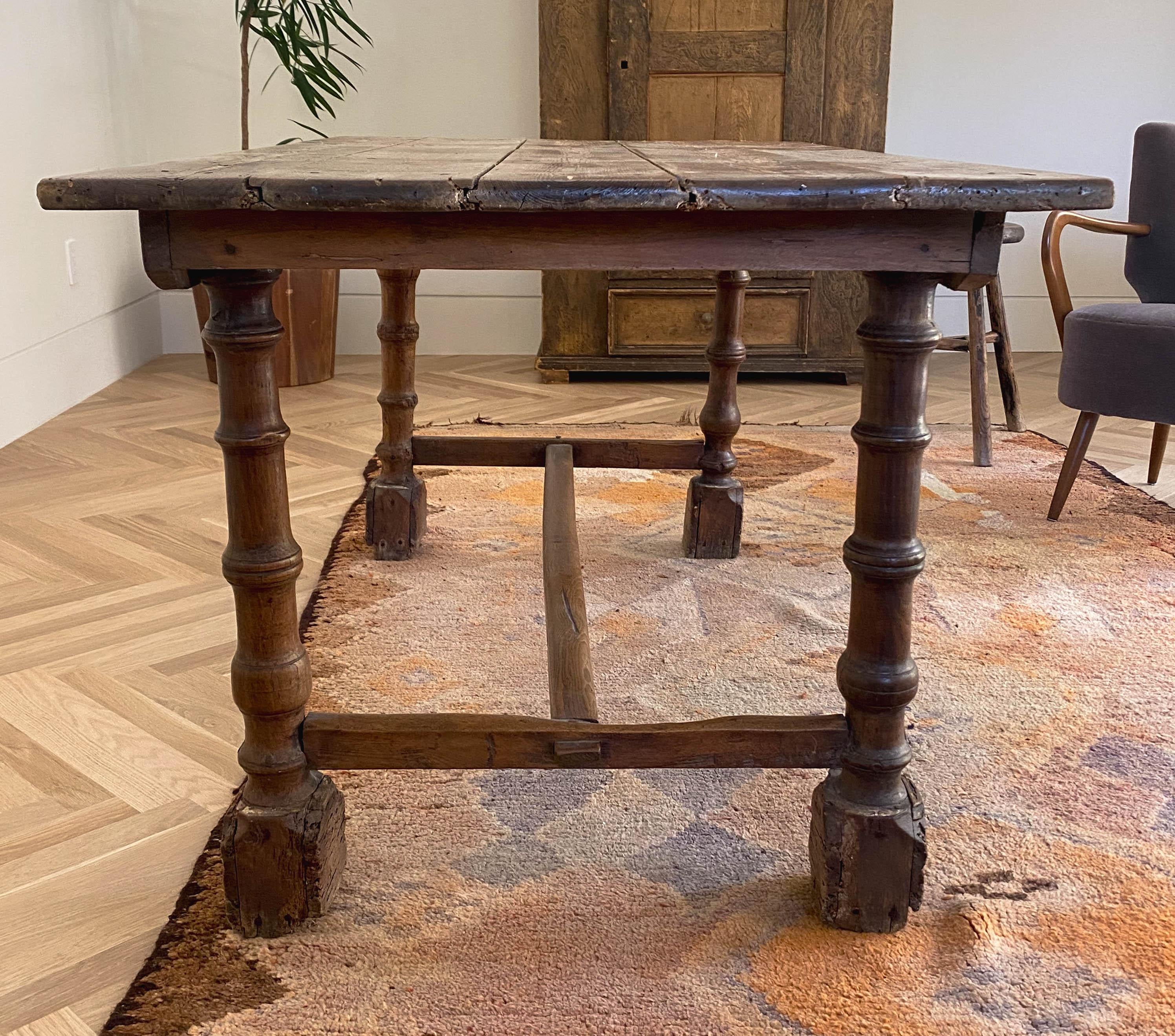 Monumental, rustic 19th century pine table with robust leg detailing and beautiful patina ideal for console, table, desk or small dining table.