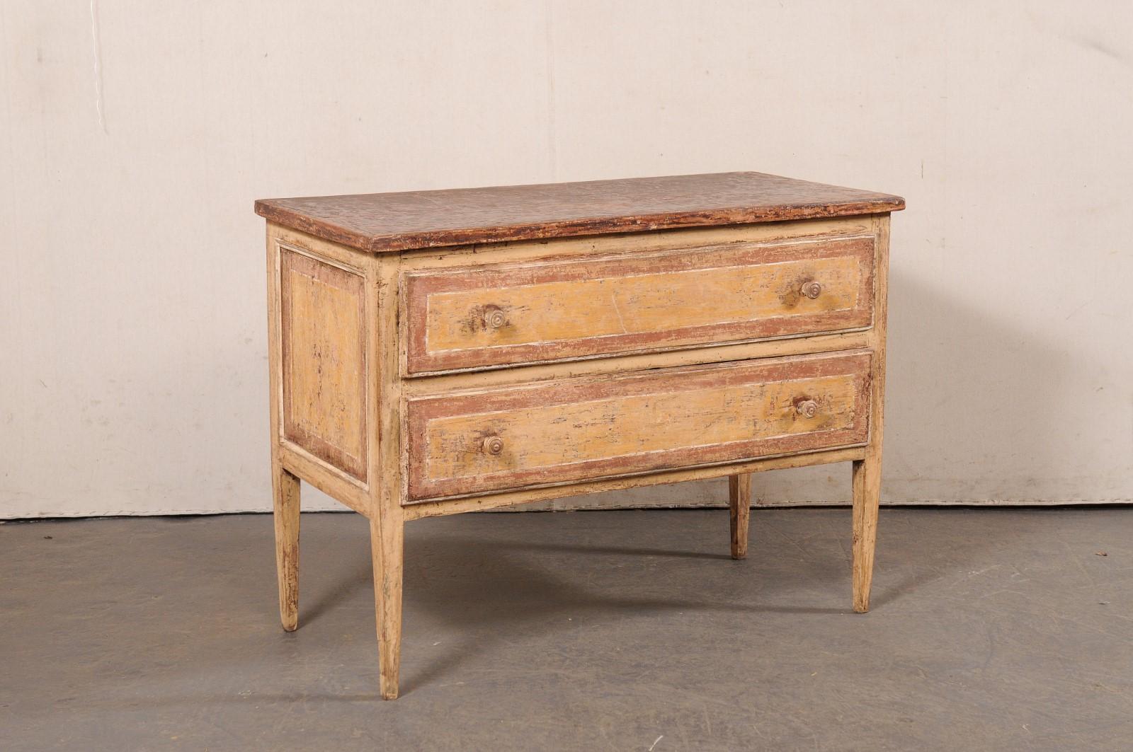 An Italian painted wood chest of two drawers from the 19th century. This antique cassettiera (chest of drawers) from Italy features a rectangular-shaped top, over a case which houses two full-sized drawers, designed in clean, linear lines, and