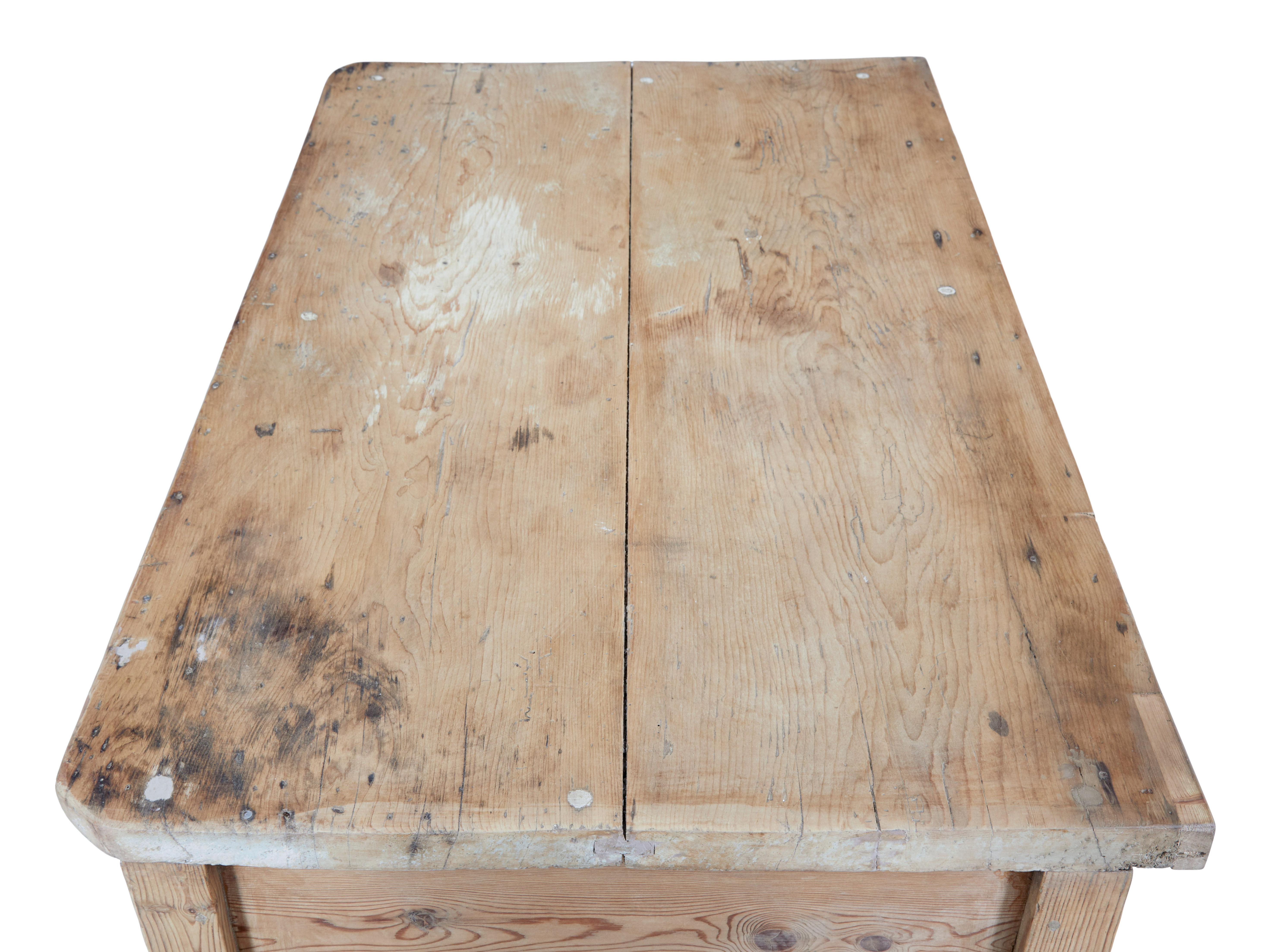 Rustic 19th century Victorian pine kitchen table circa 1880.

Here we present a table that makes and ideal kitchen table or even a desk.  2 plank pine top, with 2 drawers below which are fitted with replaced handles.  Shaped freize above the