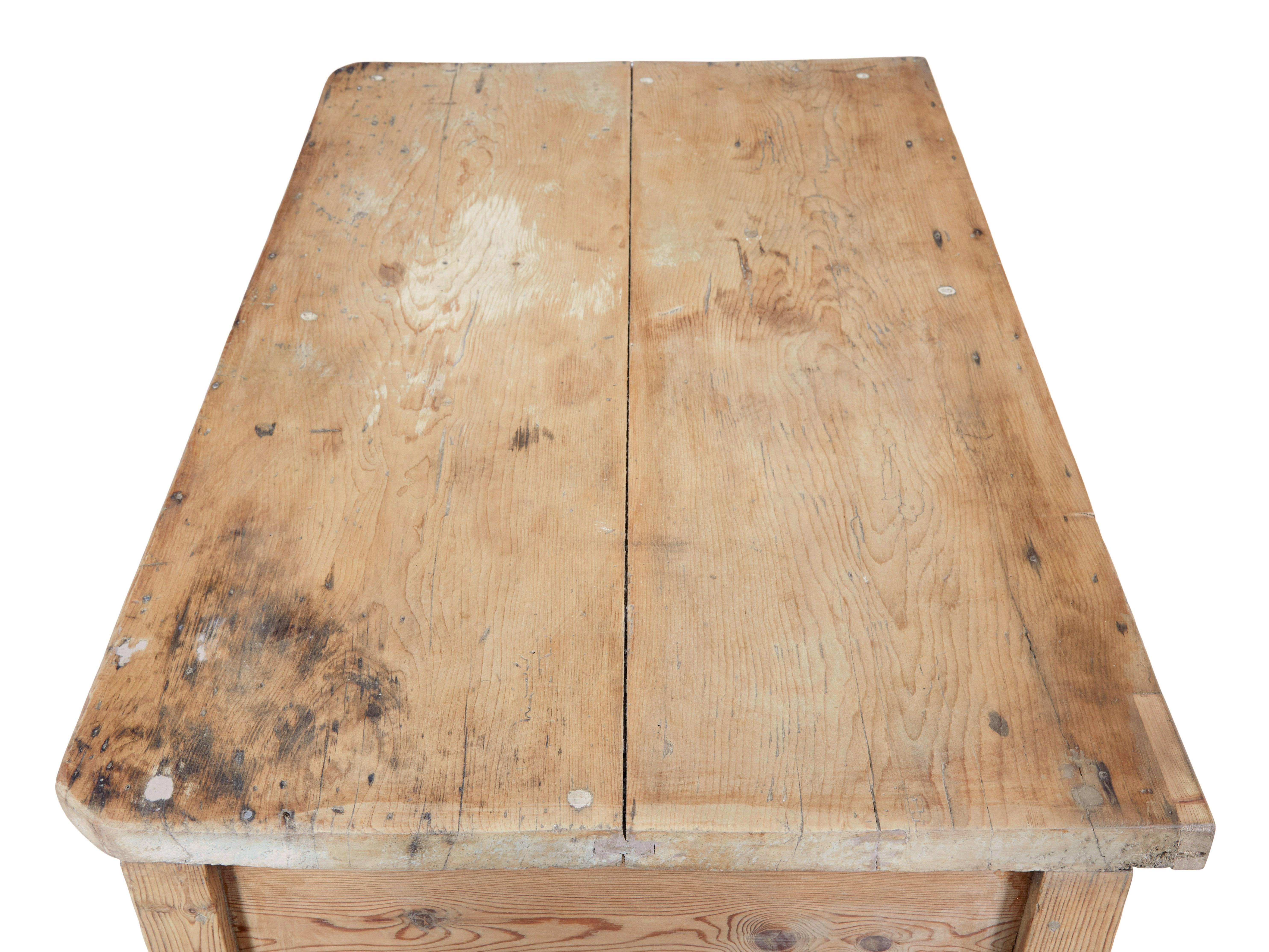 Rustic 19th century victorian pine kitchen table circa 1880.

Here we present a table that makes and ideal kitchen table or even a desk.  2 plank pine top, with 2 drawers below which are fitted with replaced handles.  Shaped freize above the knee. 