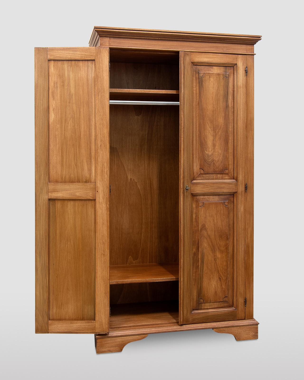 Handcrafted entirely of solid tulipwood stained walnut using non-toxic lacquers, this closet will impeccably complement rustic bedrooms. It is an exquisite example of masterful cabinet-making techniques, evident in the fine hand-carved details
