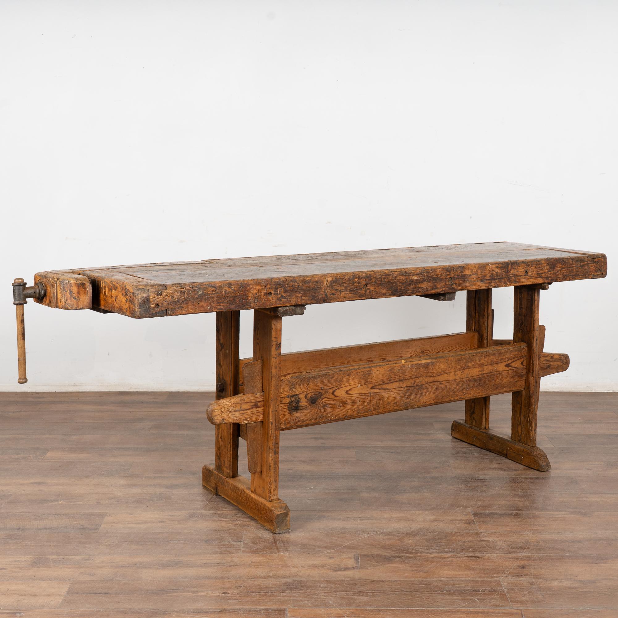 It is the years of constant use revealed in every deep gouge, ding, and scratch that enrich the character of this carpenters' workbench from Denmark.
Please examine the close up photos to appreciate the patina, joints and old hardware. 
It has one