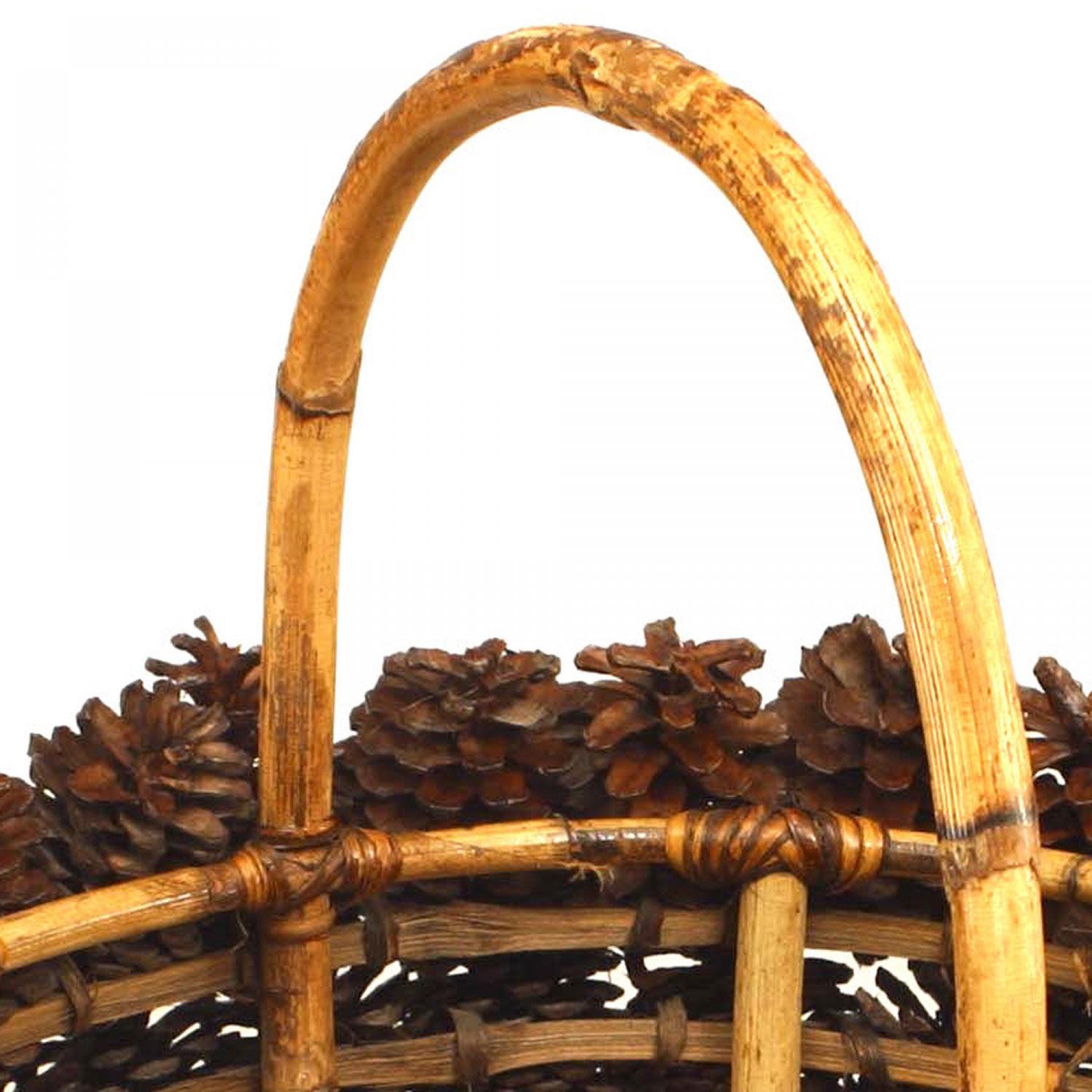 Rustic Adirondack-style (1940s) oval picnic basket covered with large pine cones and a bamboo hoop handle.