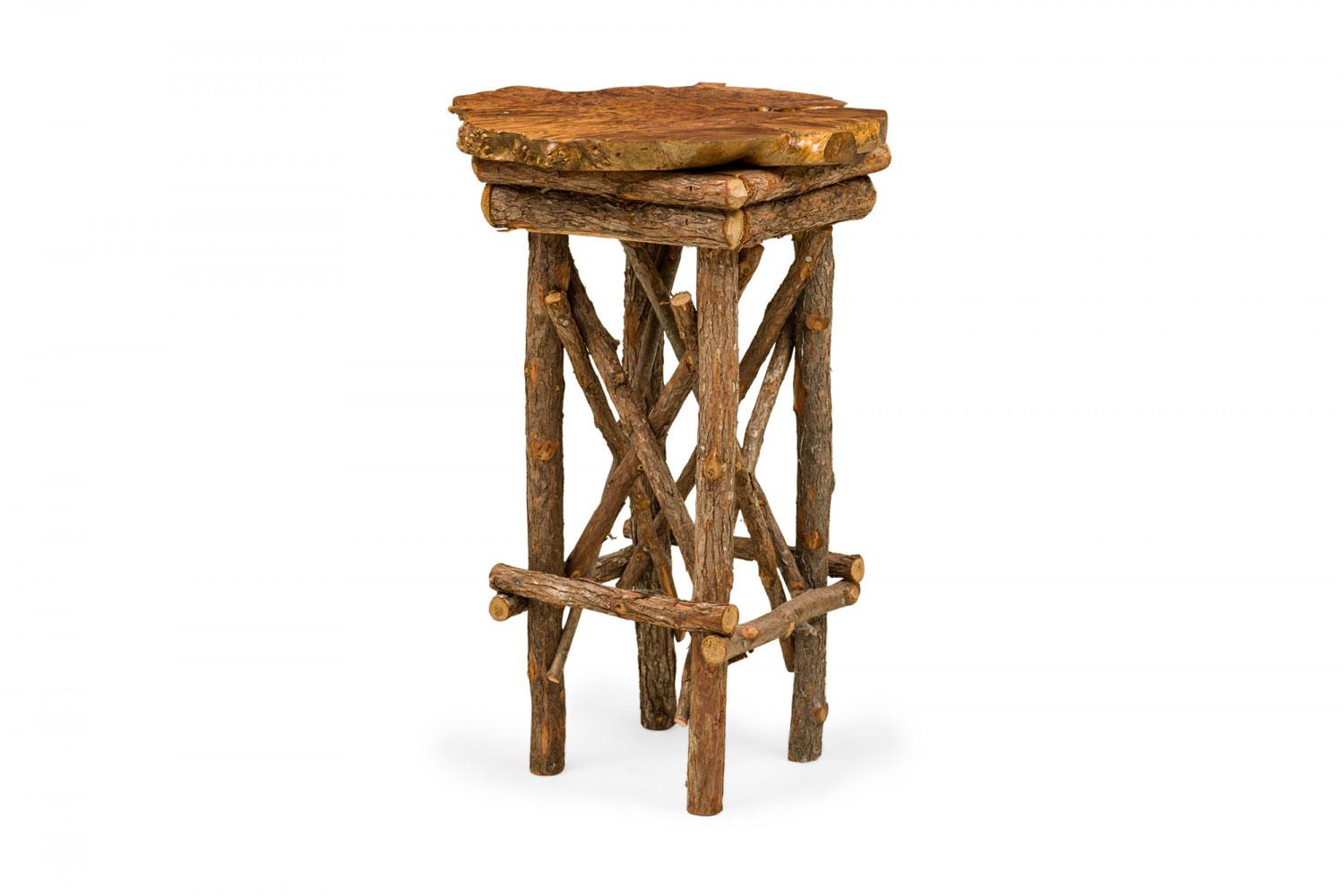 Contemporary Rustic Adirondack end / side table with a petrified wood top with organically scalloped edges supported on a branch base with x-stretchers. (Similar tables: 063373, 063375)