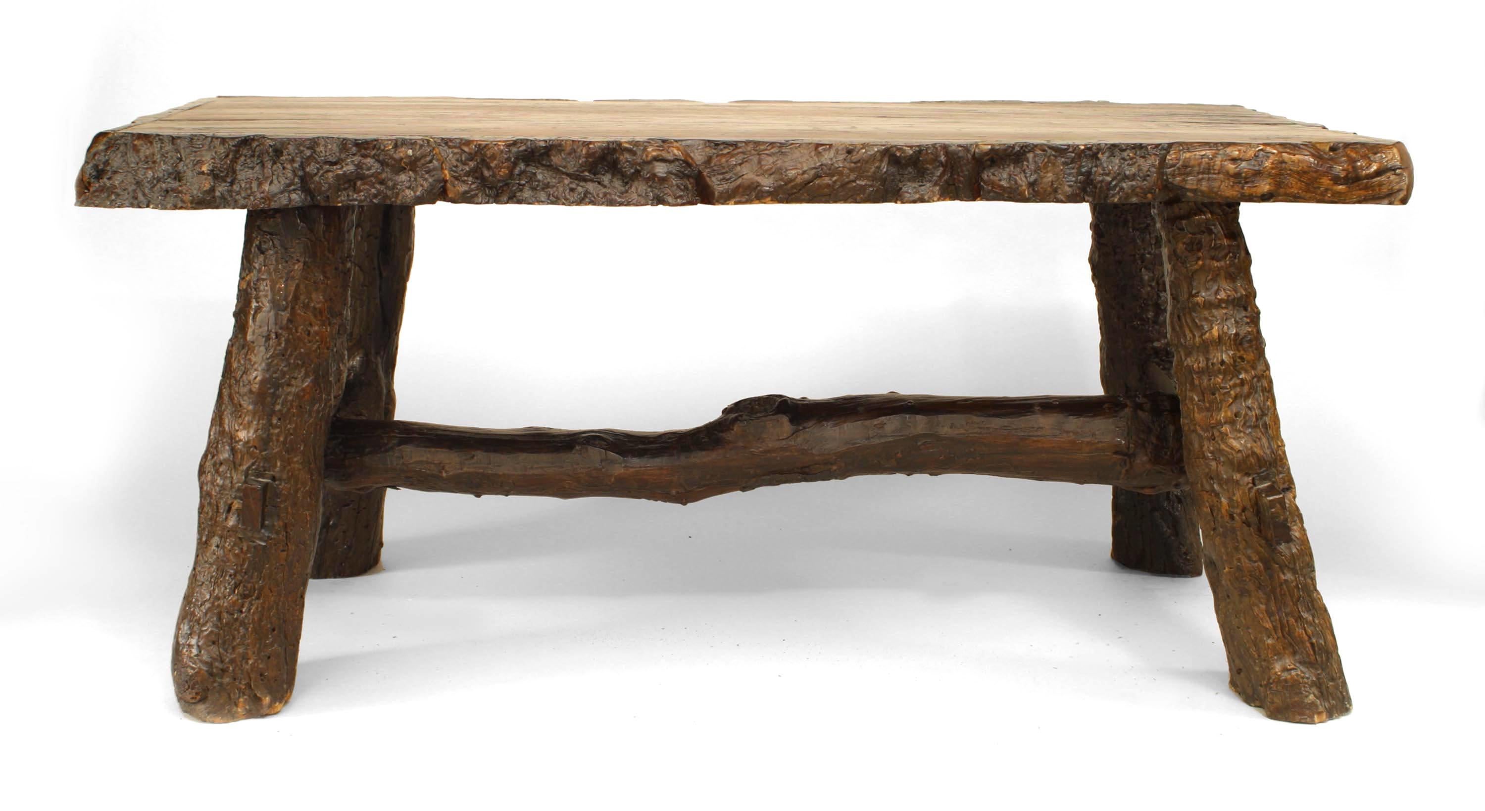 Rustic American Adirondack-style (20th Century) walnut rectangular top dining table with bark trim edge and tree trunk from legs and stretcher.
