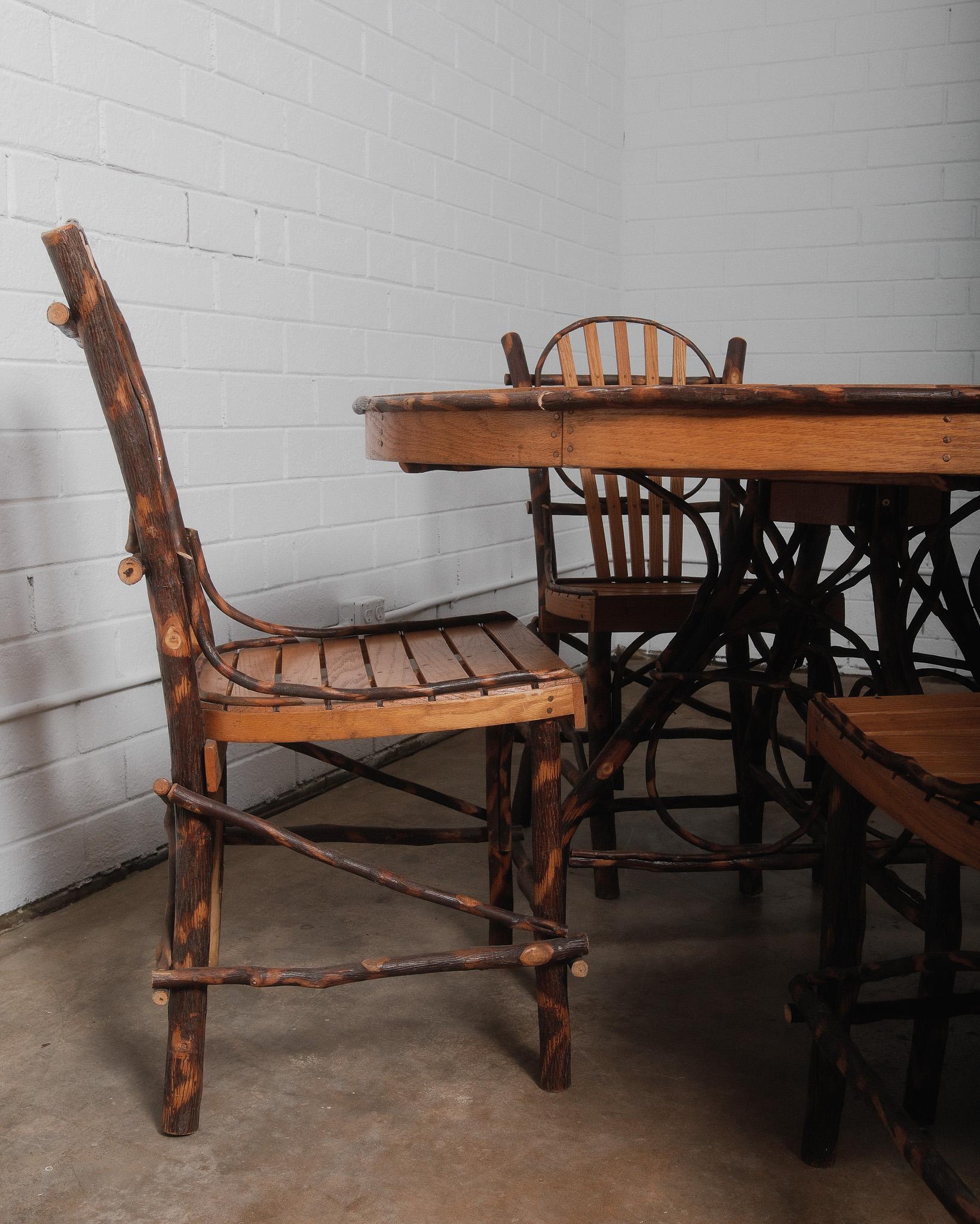 Elevate your rustic kitchen with these stunning Amish Adirondack style dining chairs and table, where the artistry of natural hickory twigs wraps around the base in a unique and elegant display. Handcrafted with meticulous care, each chair features