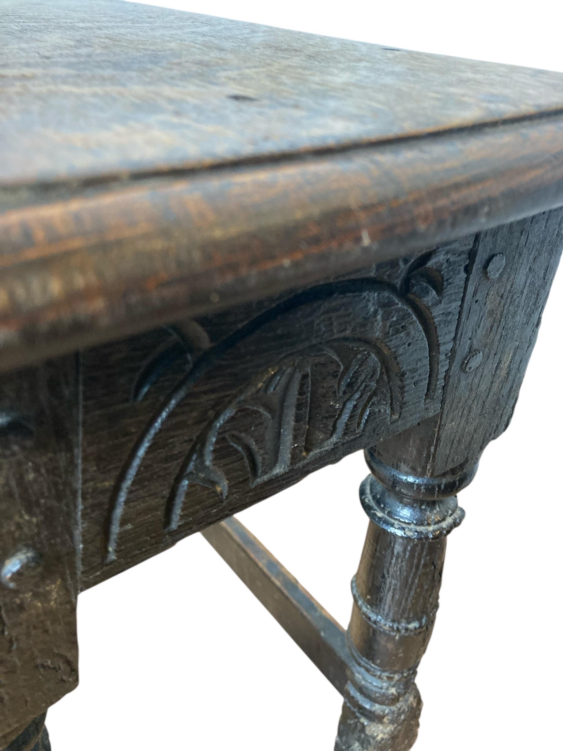 Carved Oak Joined Stool 17th Century Charles II with a lunette carved frieze. Circa 1645 this 400 year old stool has such antique character and has a range of use such as plant stand or small side table. Discover the timeless charm of our exquisite