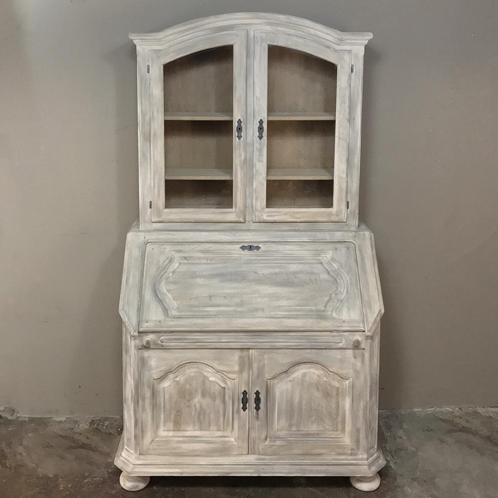 This rustic antique Country French secretary bookcase features clean lines with subtle design flair that make it the ideal choice for the casual decor!  Given a stripped finish that is so in vogue today, it was handcrafted with double-pegged mortise