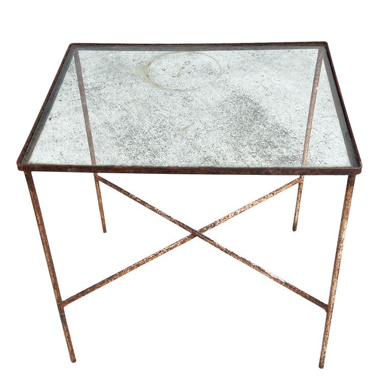 A rustic early American iron and glass accent table. This table was taken from the estate of an Oklahoma oilman in Tulsa Oklahoma. His estate is located next door to the Belvedere House in Downtown Tulsa. The home in itself is a historical home. We