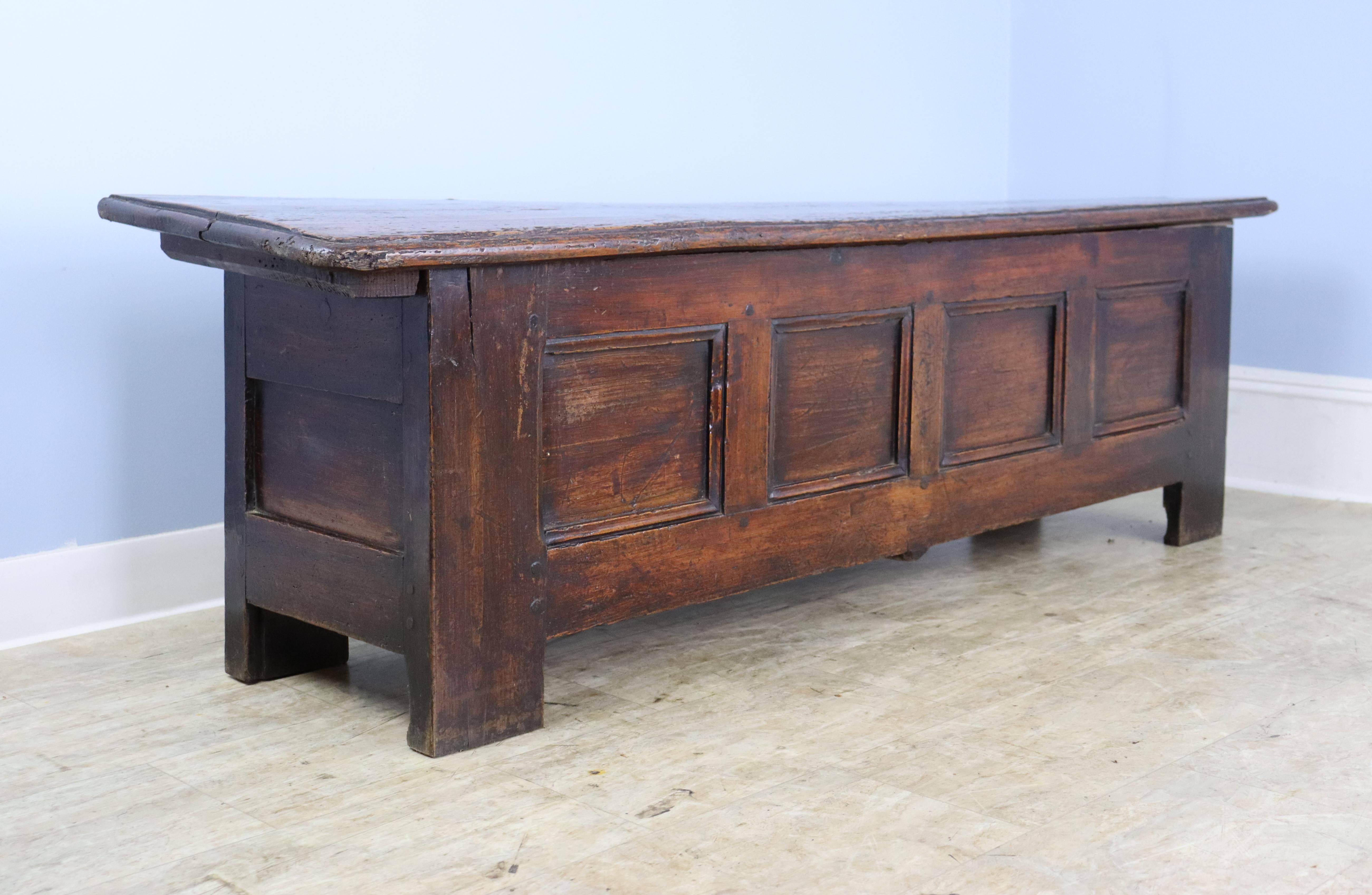 An antique pine coffer from France. Nice age and patina. Top lifts up for good storage. Works well at the foot of a bed or under a window, as a narrow coffee table and as a blanket chest or trunk. A good bench height, for sitting. The top of this