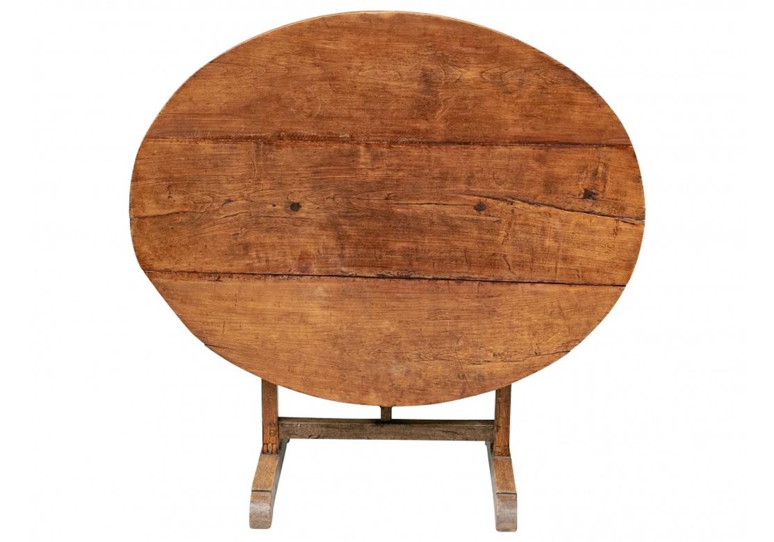 Also known as a Vandage or Vintner’s Table. With an oval plank constructed top mounted on square legs on a trestle base. The flat stretcher with V shaped support for the top, the base is Mortise and Tenon construction. Folds for storage and may be