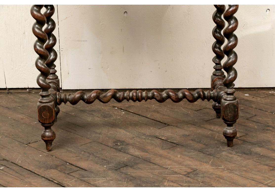 Authentic oak Tavern table with nicely carved Barley twist legs and stretcher, banded top, single divided drawer with key (non-working) as drawer pull and peg construction. The table has a fine Rustic presentation and an overall nicely time softened