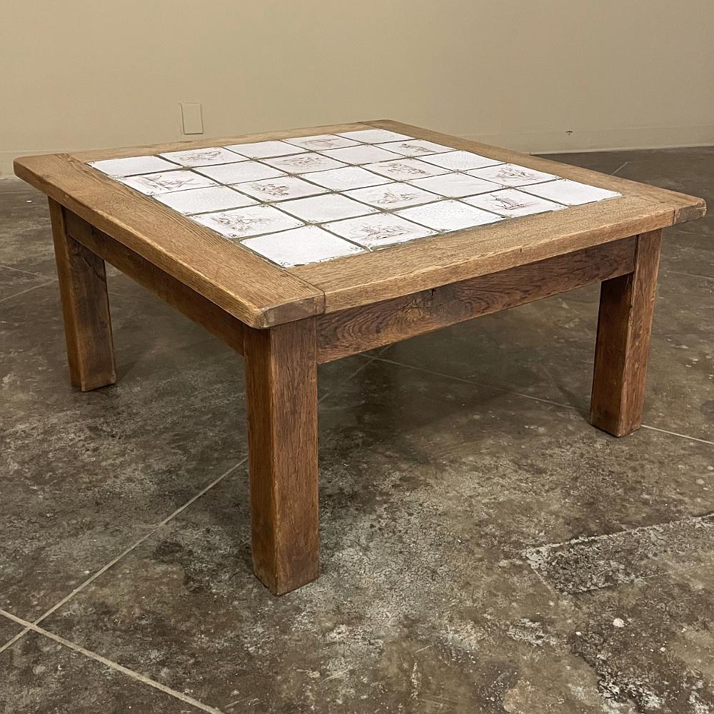Rustic antique oak coffee table with hand-painted delft tiles will make a charming addition to your casual decor! Solid oak planks were used to create the framework for the top, as well as the supporting aprons underneath, with four square oak