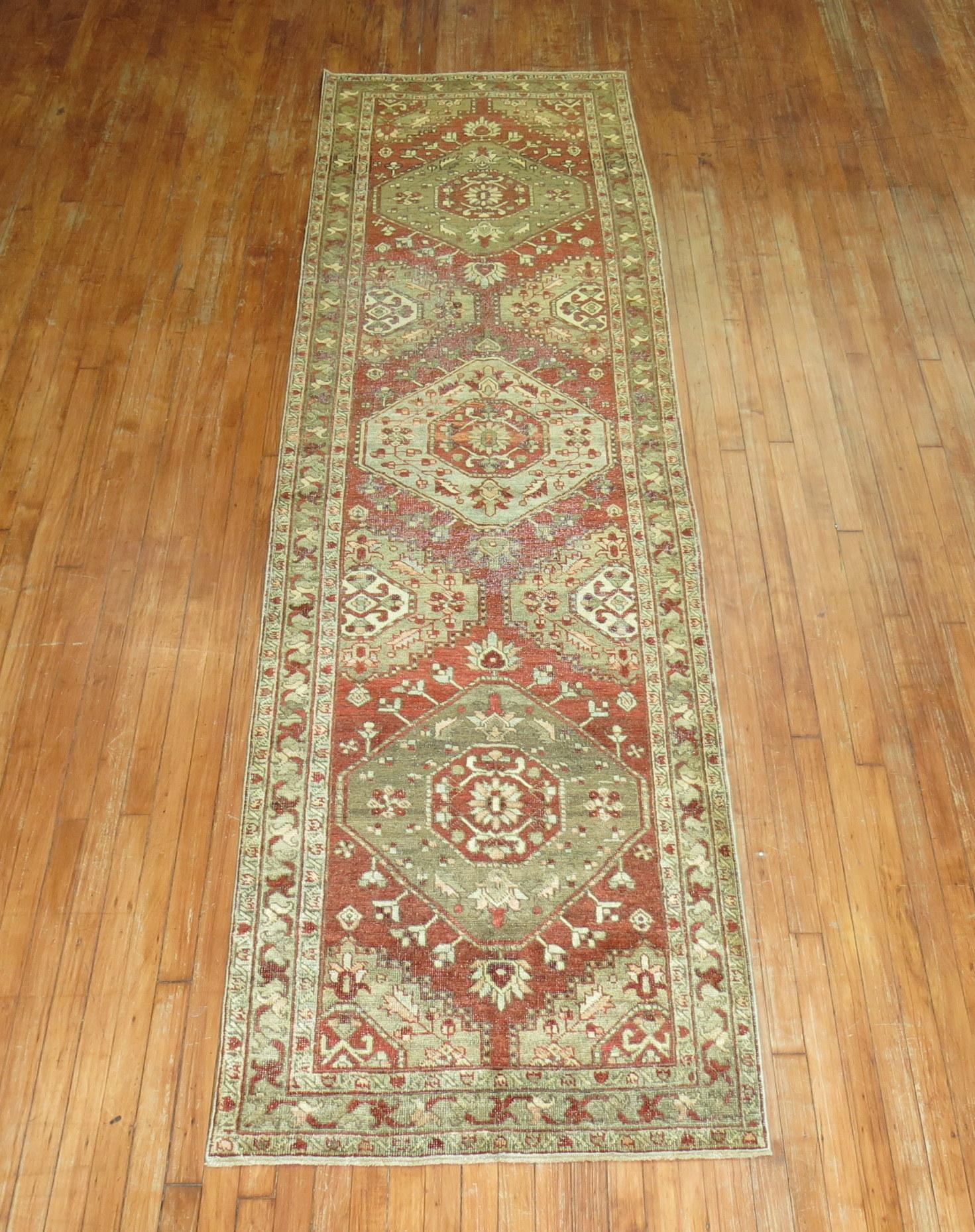 Decorative Persian Heriz one of a kind antique runner from the early 20th century with rustic colors

Measures: 3' x 10'9