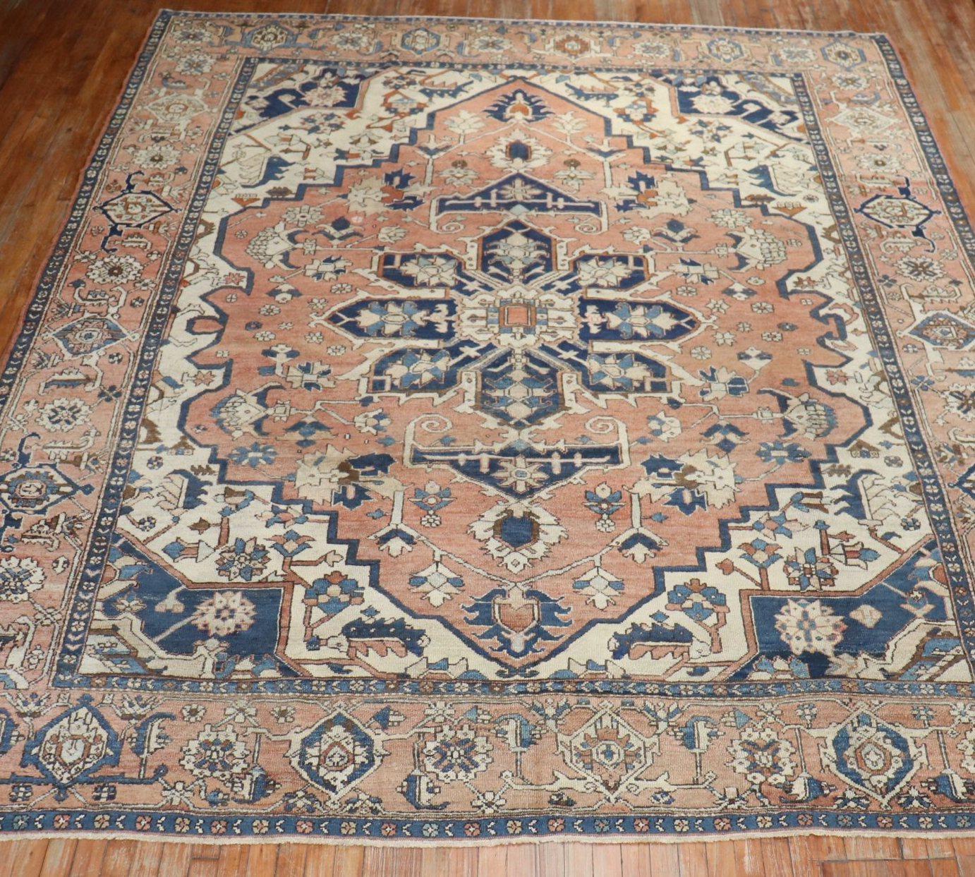 Room size Persian Heriz rug. Light rust, accents in antique white and navy.

Measures: 9'11
