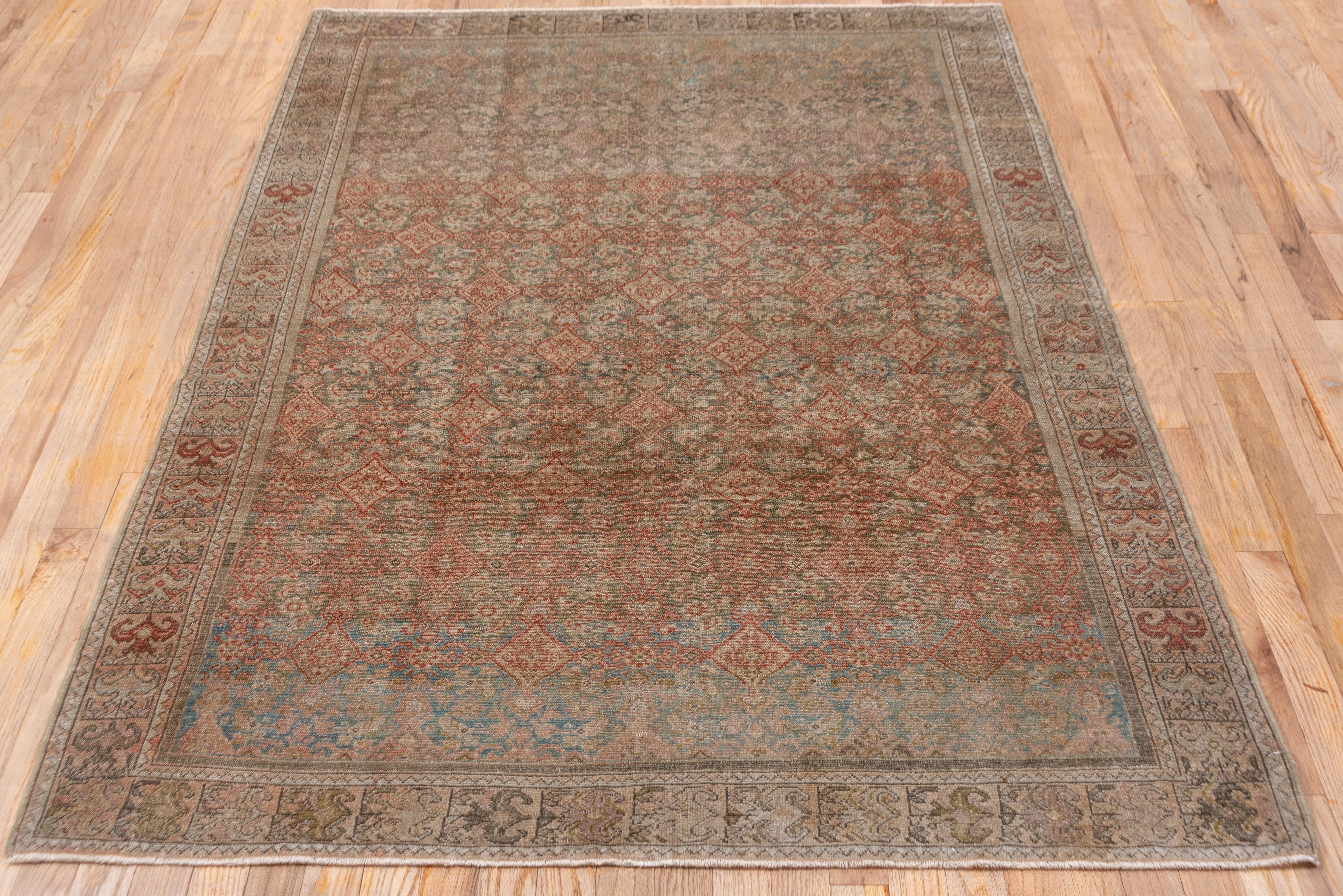 The abrashed camel-tone field displays a bold grey-blue medallion with a central branching rust sub-medallion. Rust details in corners and border. Worn low overall, fair condition.
  