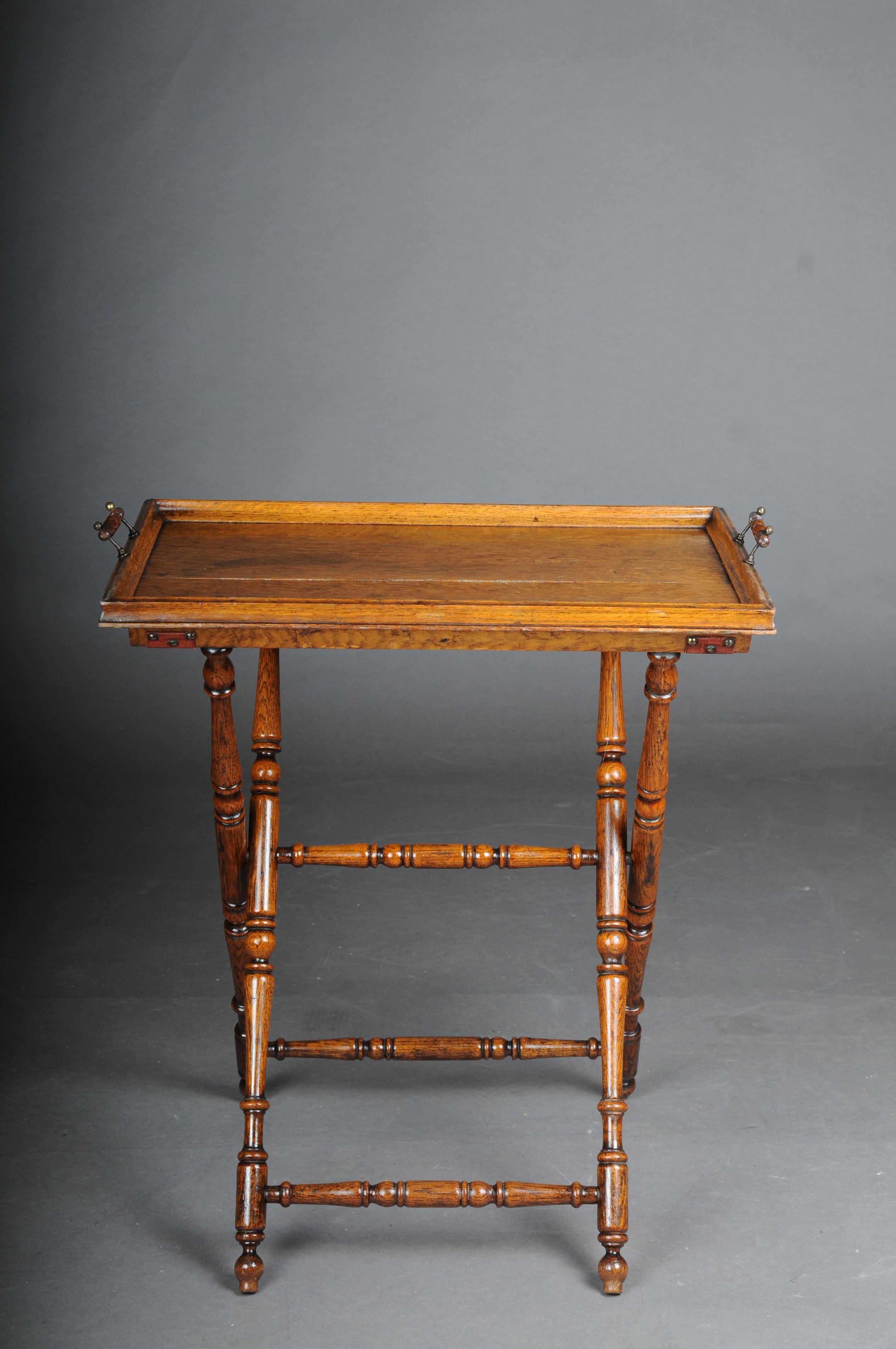 Rustic antique tray table, oak, Germany

Solid oak wood, foldable X-shaped base, turned. Removable tray with 2 handles.