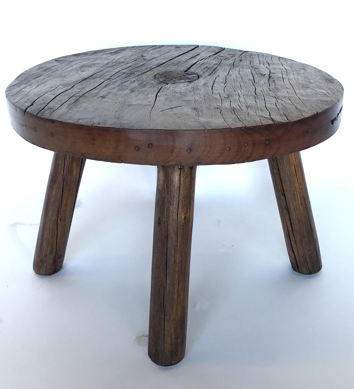 This rustic little round side or end table consists of a 19th c wooden wheel from Guatemala and vintage legs made from teepee poles! Natural, rustic but smooth patina throughout. Wax finish.