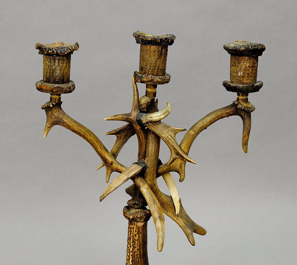 A candleholder, made of horns from the deer, fallow deer and wild boar tusks. Three candle spouts made of horn and wood. Executed, circa 1900.

Measures: width 13.78