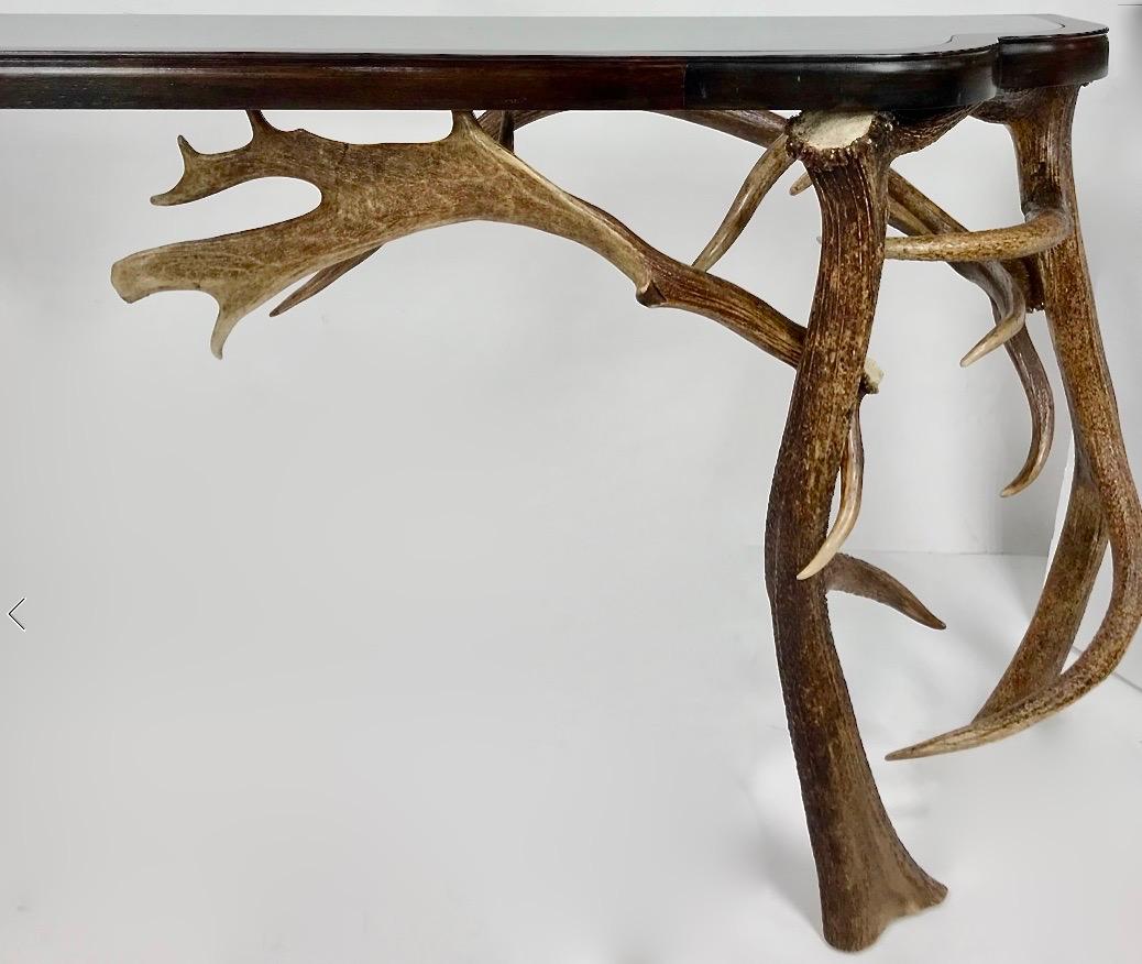 An absolutely stunning console table comprised of naturally shed elk and European fallow deer antlers. The artist definitely spent time and artistry laying this out and creating this lyrical and functional piece. NOTE: These antlers are all shed